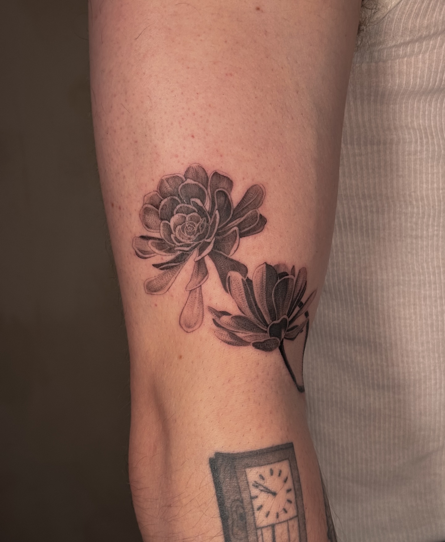 Flowers black and grey tattoo on the forearm by Floral