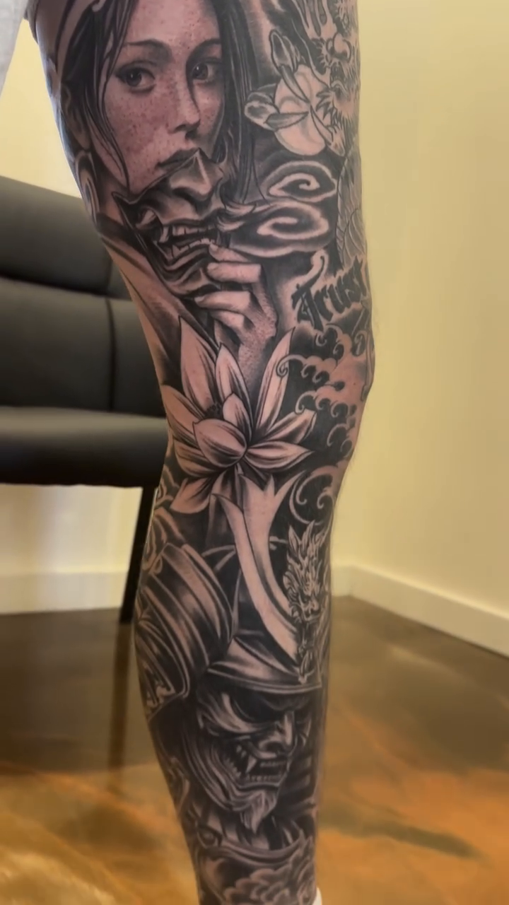 Woman with lotus flowers realism tattoo by Mason Williams