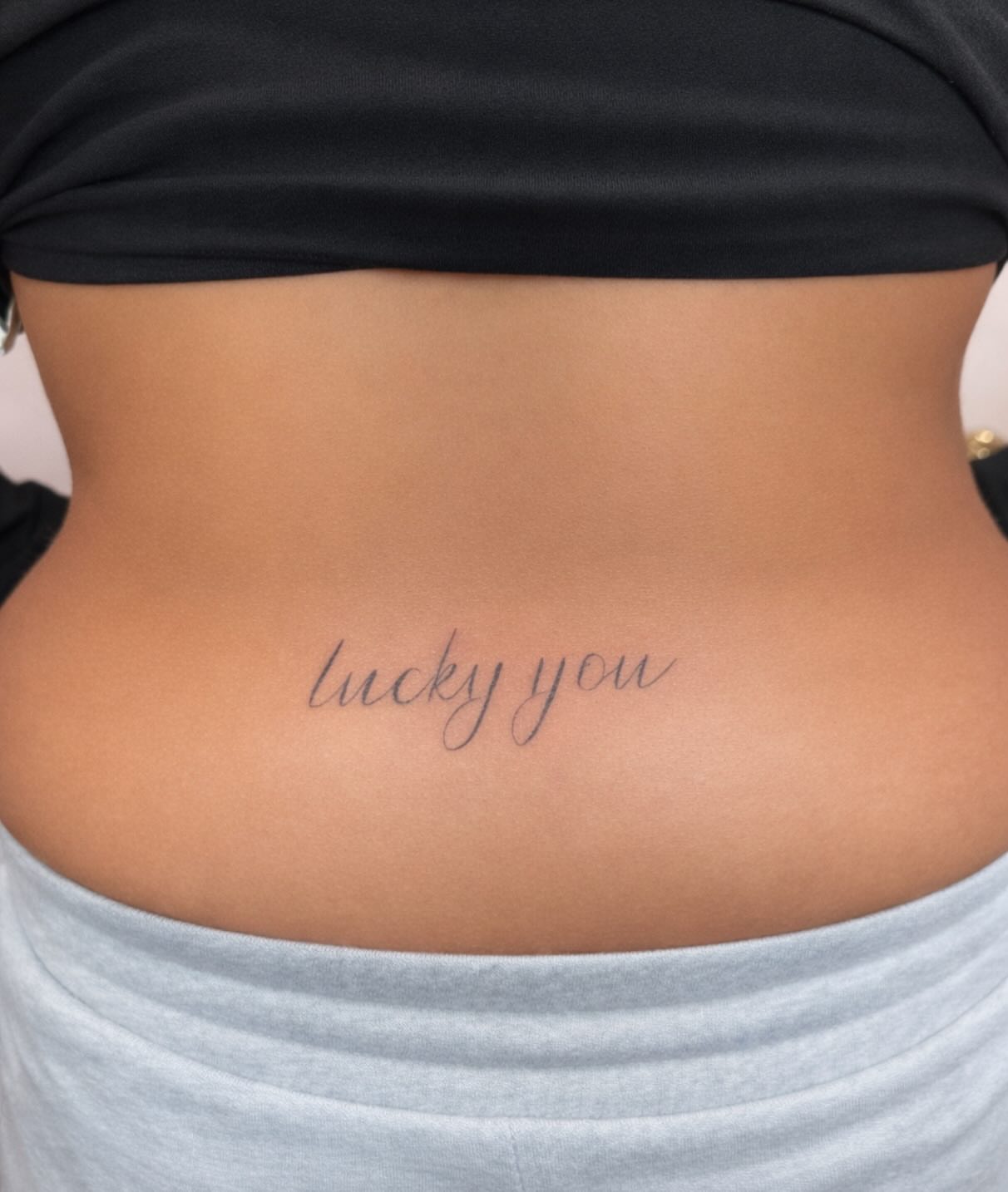 Lucky you lettering script tattoo on the torso by Lexie Decker, Canton, Ohio
