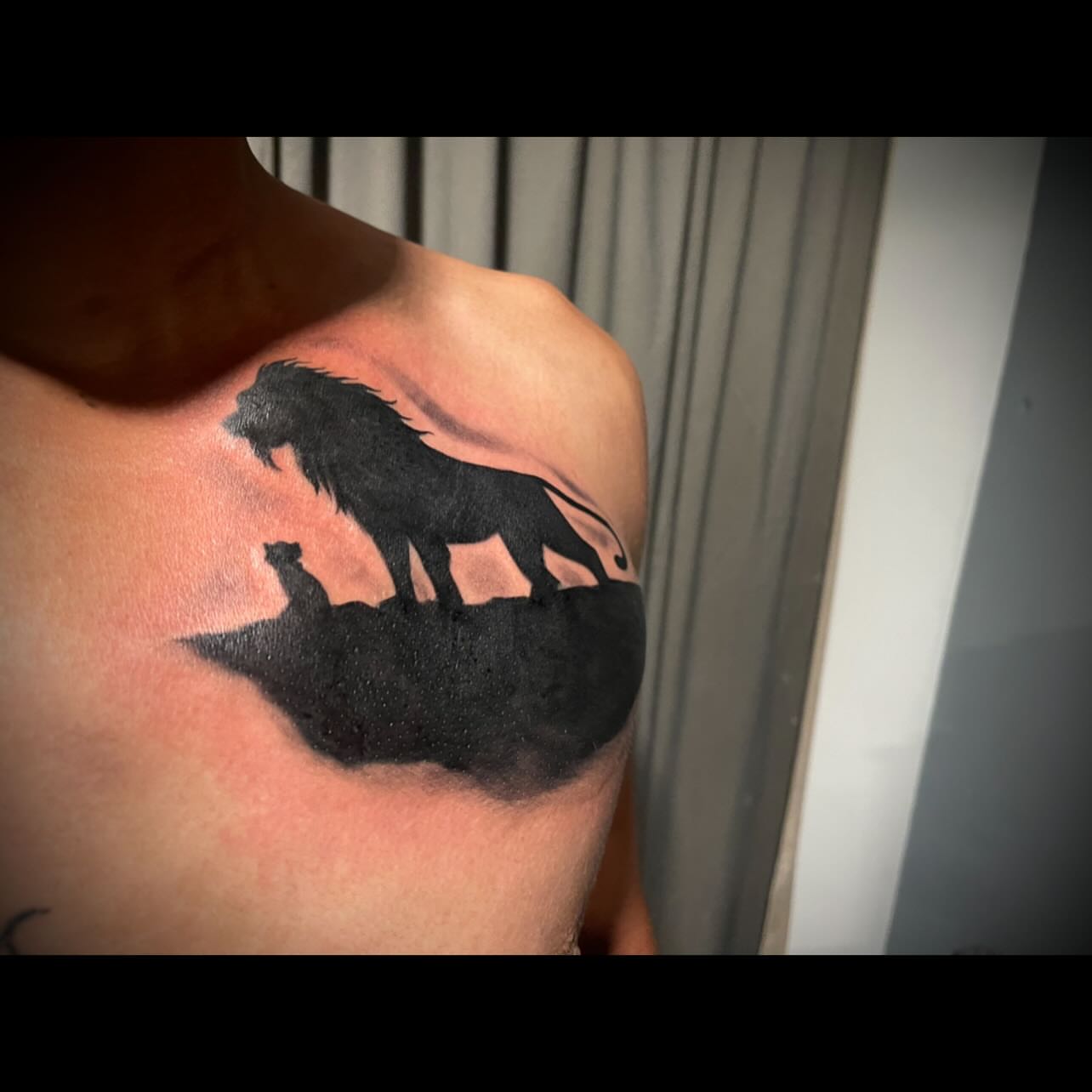 Lion and cub black and grey tattoo on the shoulder by Tu SanchoTattoos