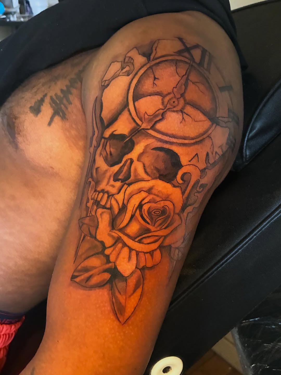 Skull and rose with clock realism tattoo on the thigh by Detroit tattoo Artist