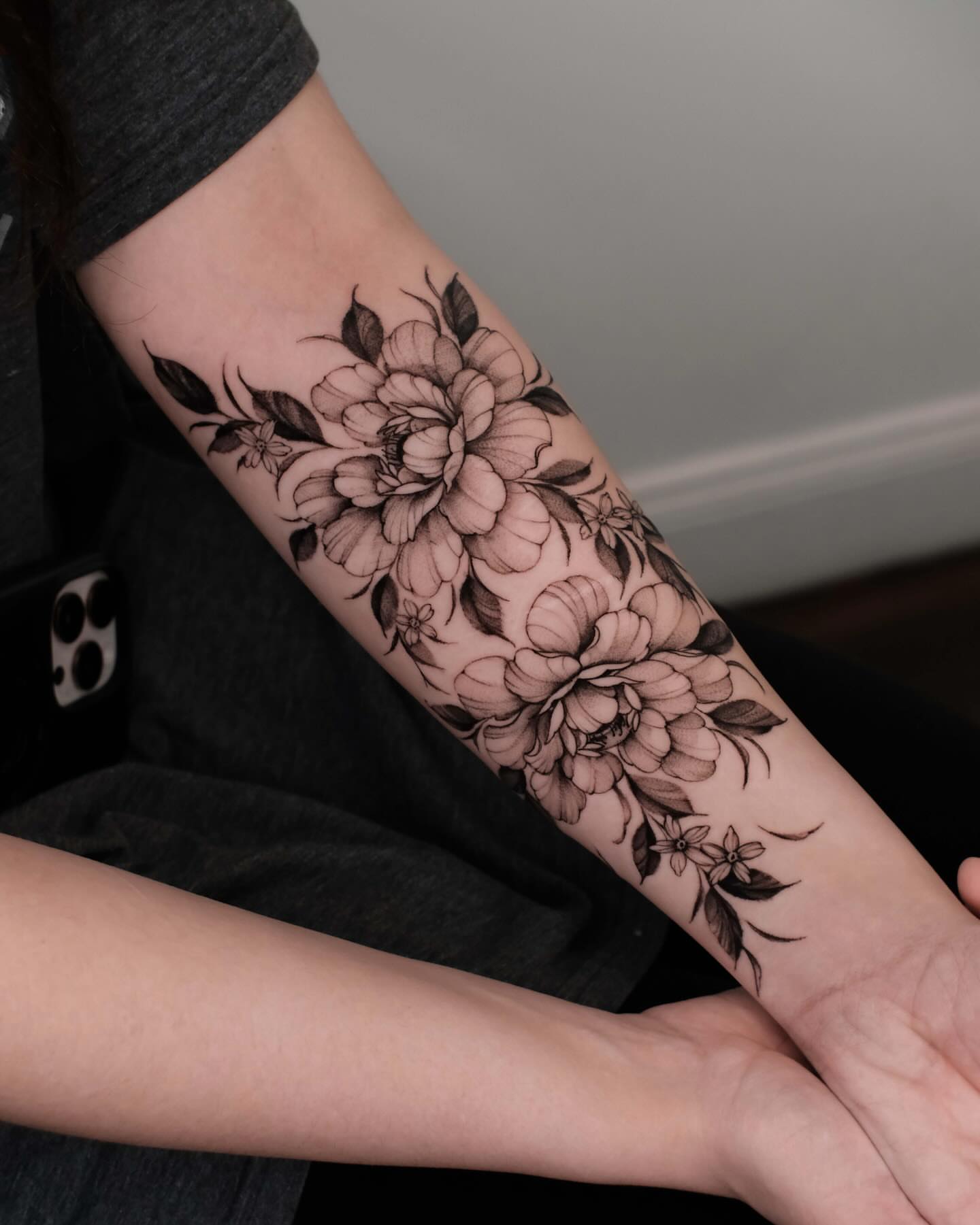 Floral bouquet black and grey tattoo on the forearm by Anastasiia