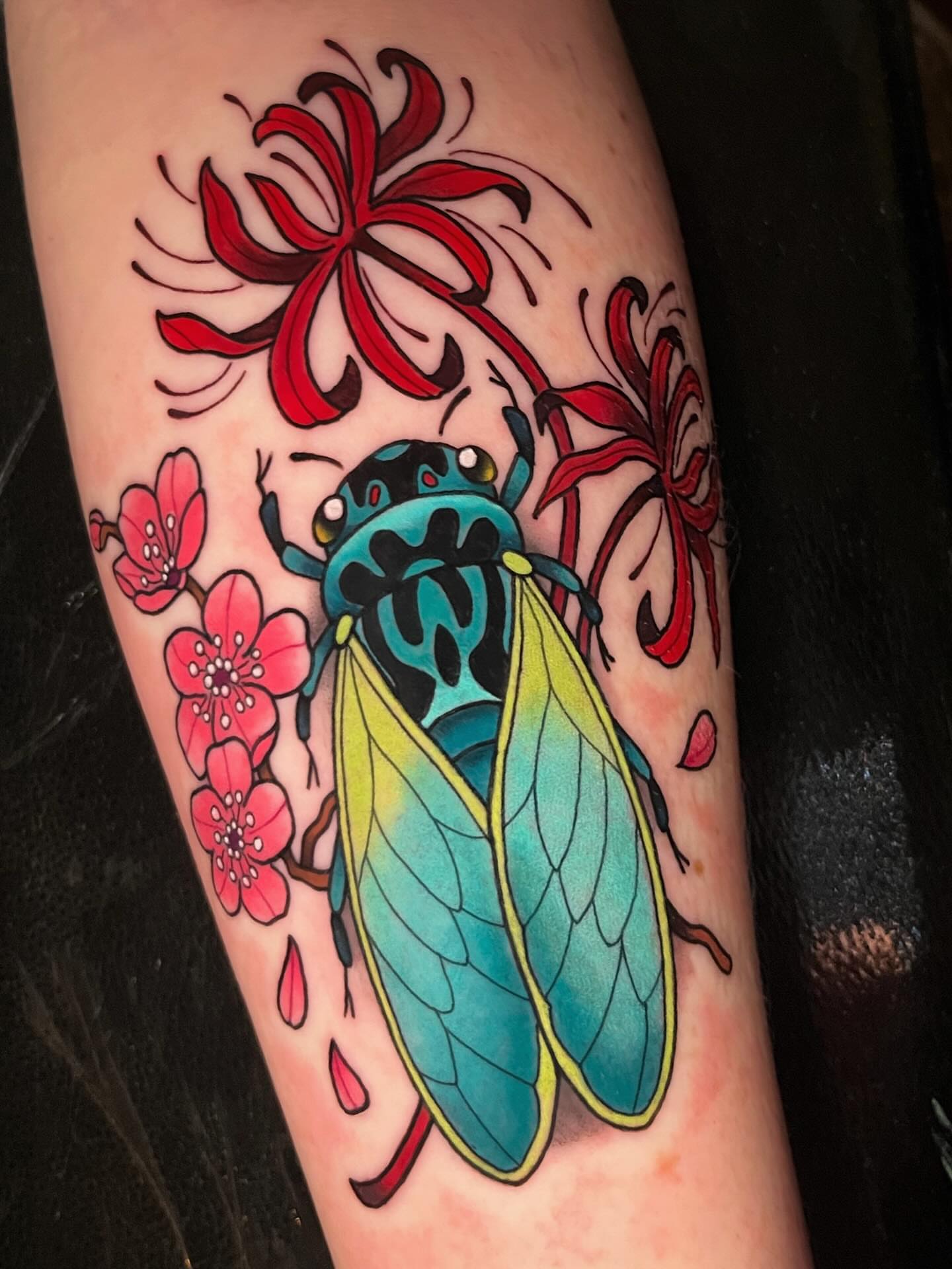 Cicada and flowers American traditional tattoo on the forearm by Nicole Skalski
