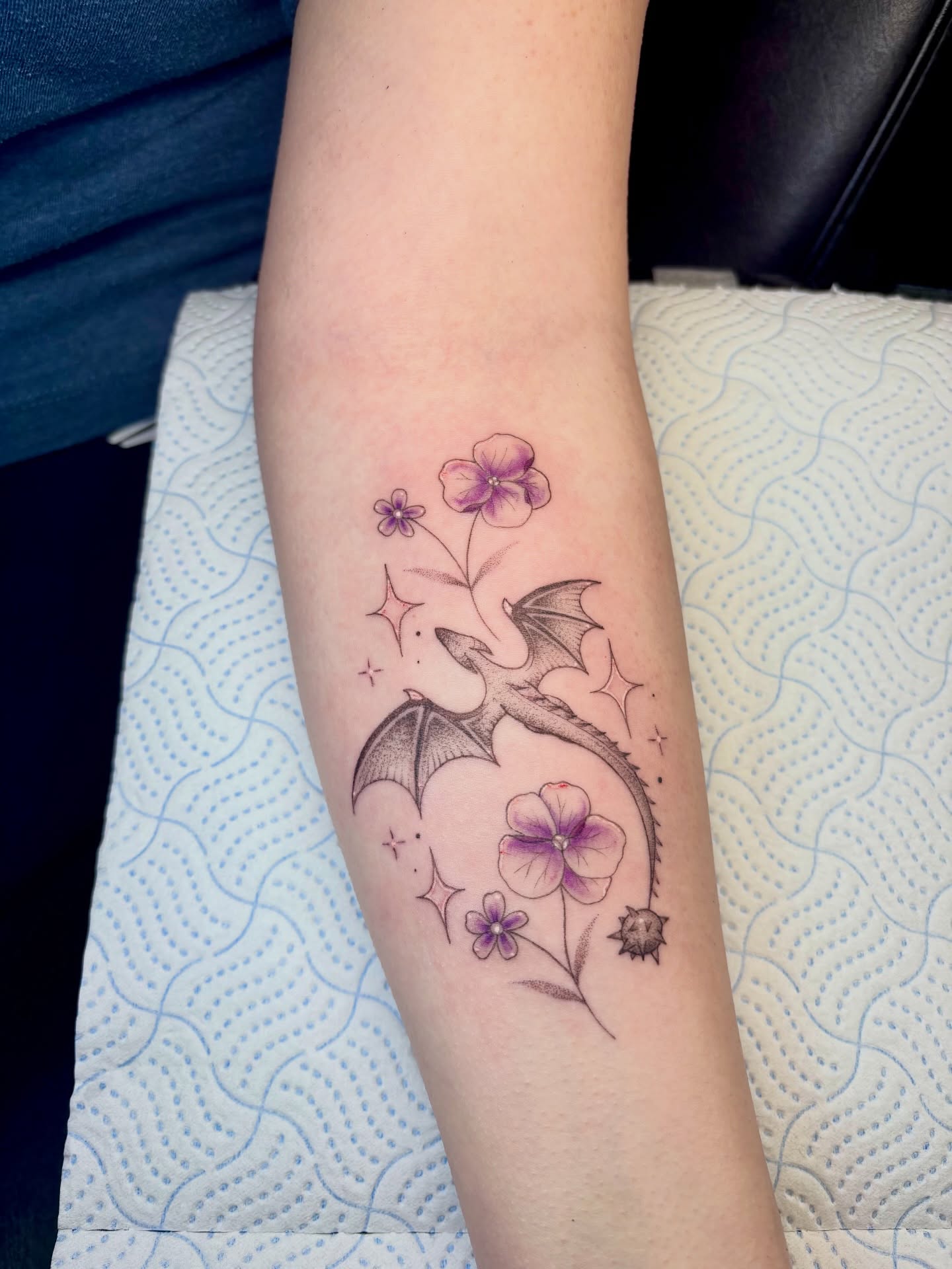 Dragon and flowers dotwork tattoo on the forearm by Charlotte Brown, Leeds, England