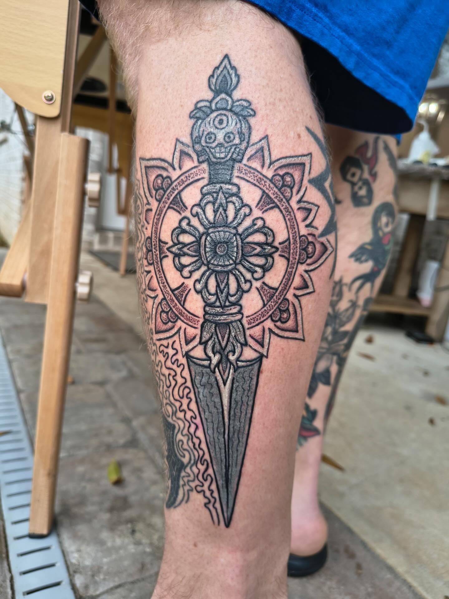 Sword and mandala geometric tattoo on the leg by Ravi Chandra, Mount Shasta, California