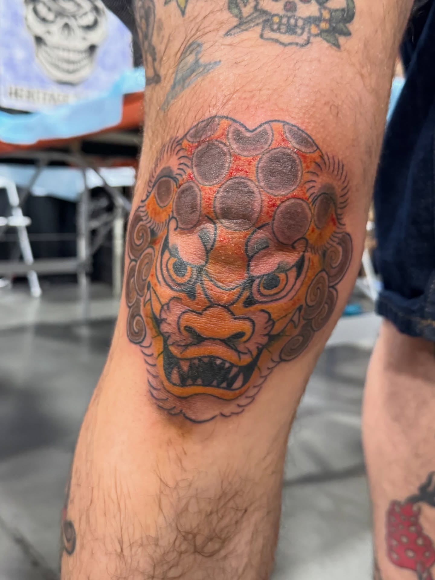 Lion mask dotwork tattoo on the leg by Dylan
