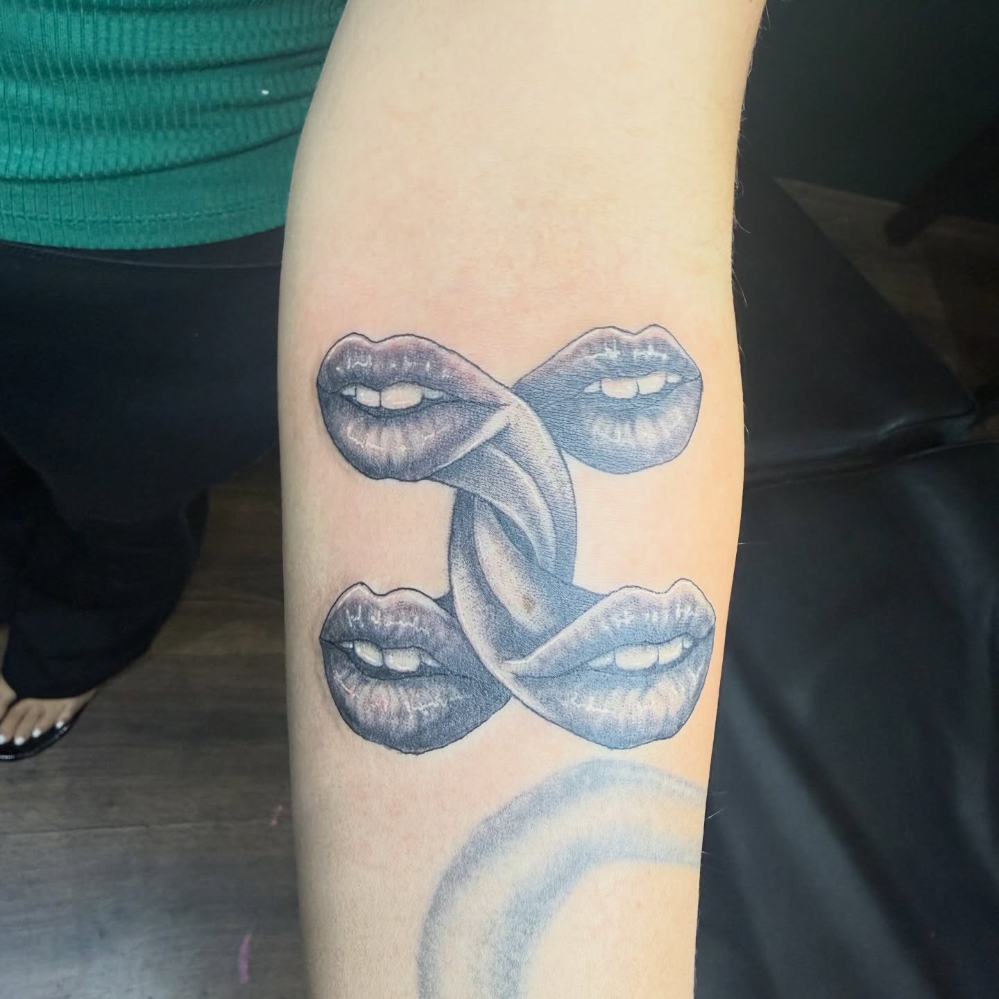 Lips black and grey tattoo on the forearm by Teara faith krigbaum