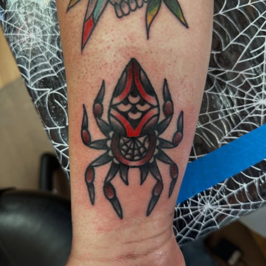Spider American traditional tattoo on the forearm by norawillstattoo