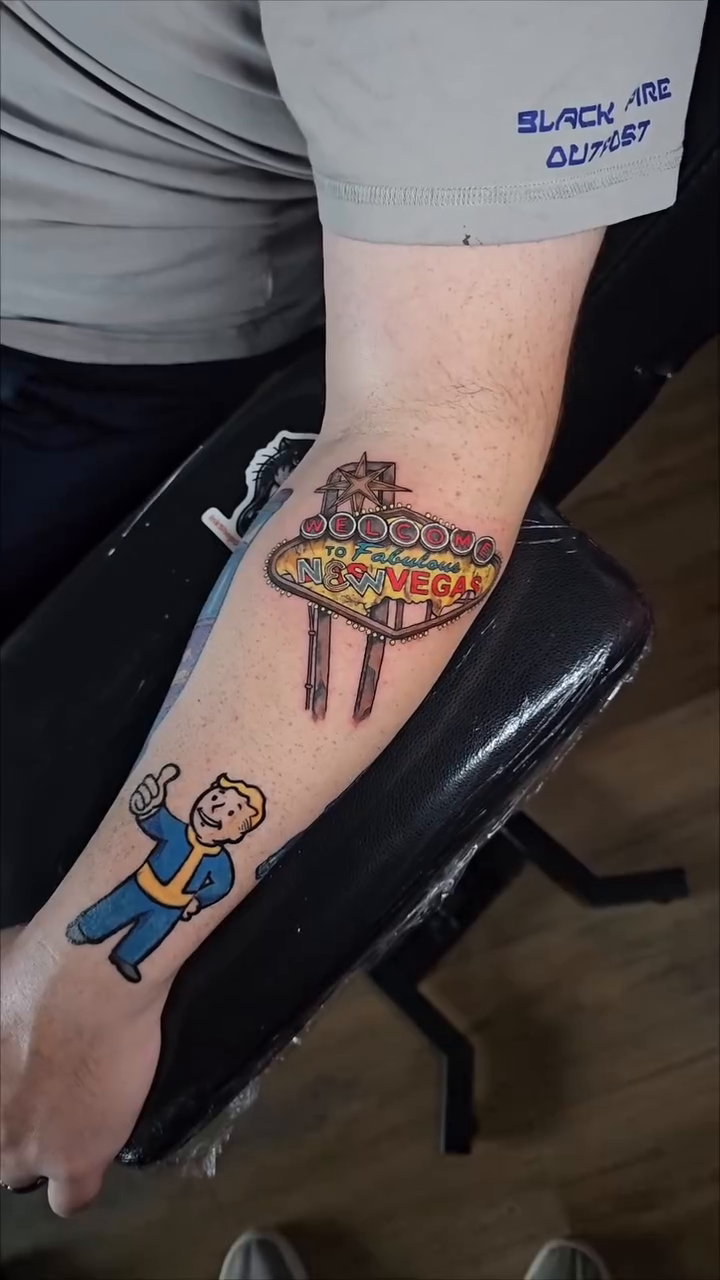 Las Vegas sign and Fallout character new school tattoo on the forearm by John Briceño, Columbus, Ohio