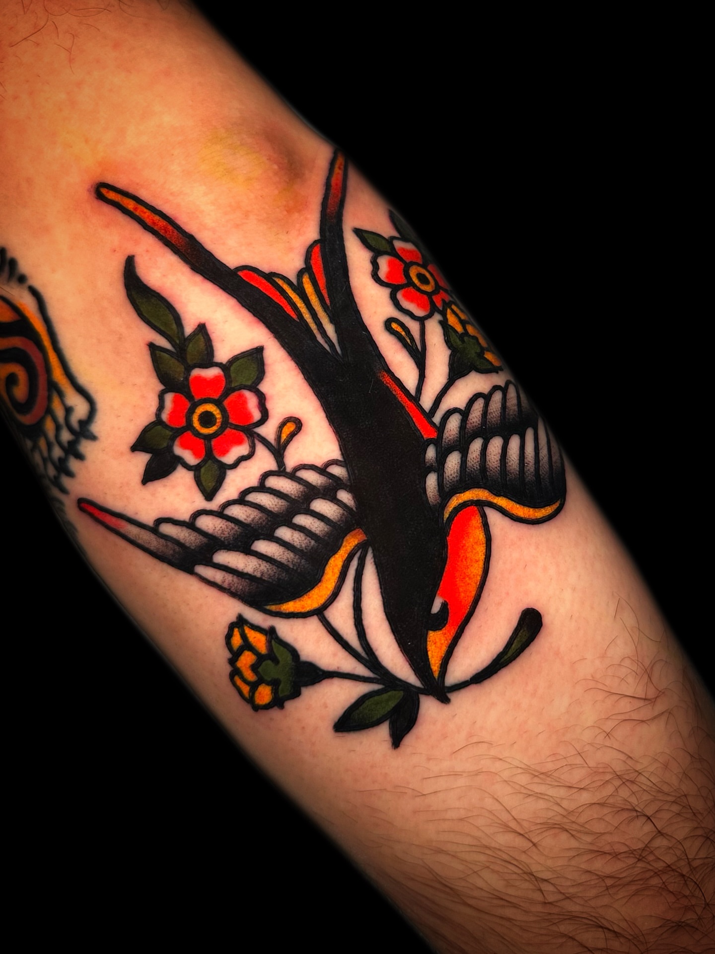 Bird and flowers American traditional tattoo on the forearm by Danny Reis