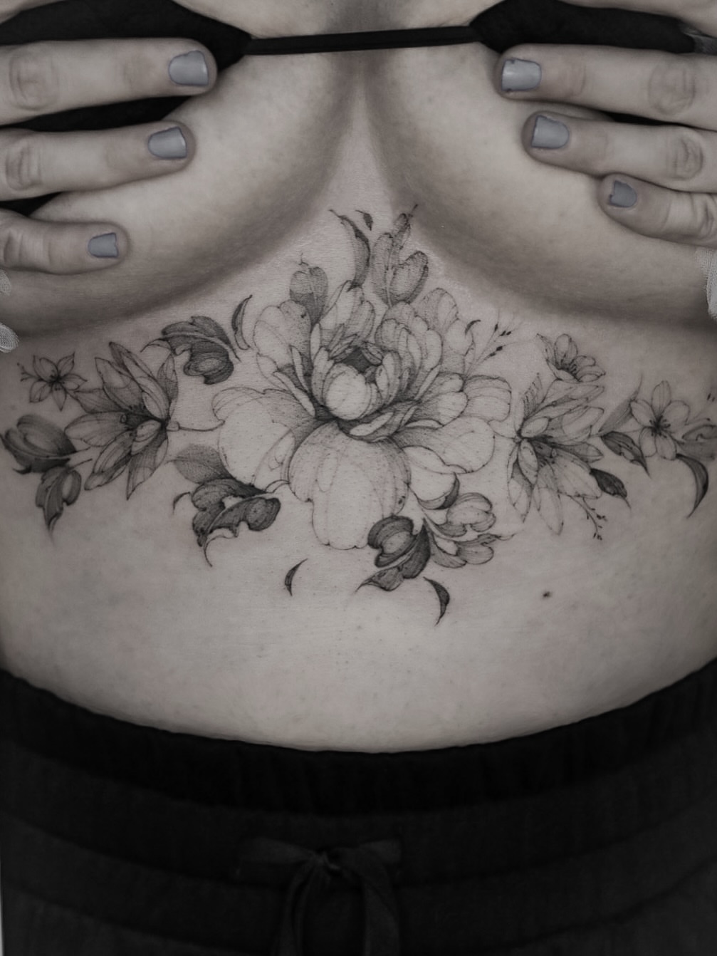 Floral bouquet black and grey tattoo on the chest by Maria