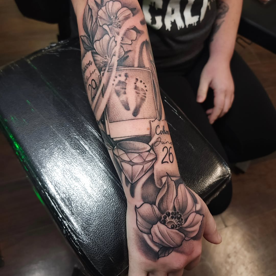 Baby footprints, diamond, and flowers sketch tattoo on the forearm by Chris Wodarski