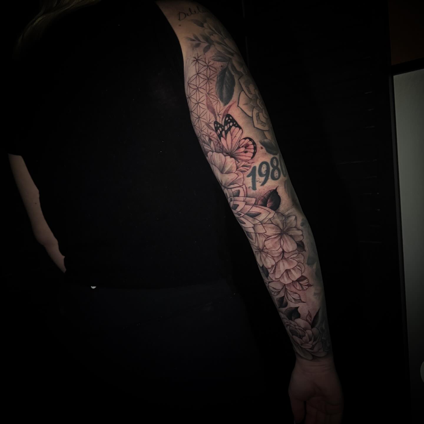 Floral and butterfly geometric tattoo on the forearm by Sad Girl Tattoos