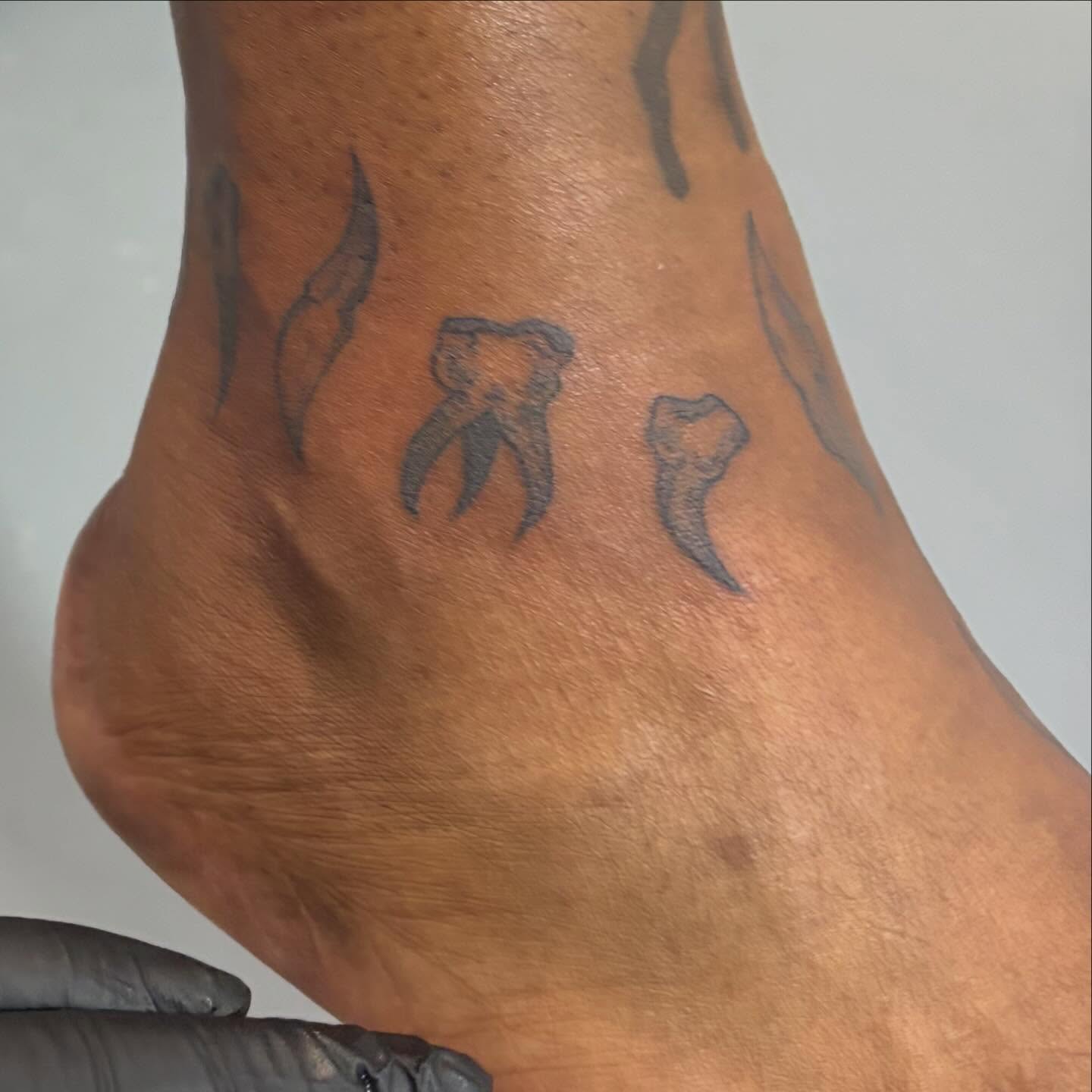 Teeth black and grey tattoo on the foot by Dont Worry About It