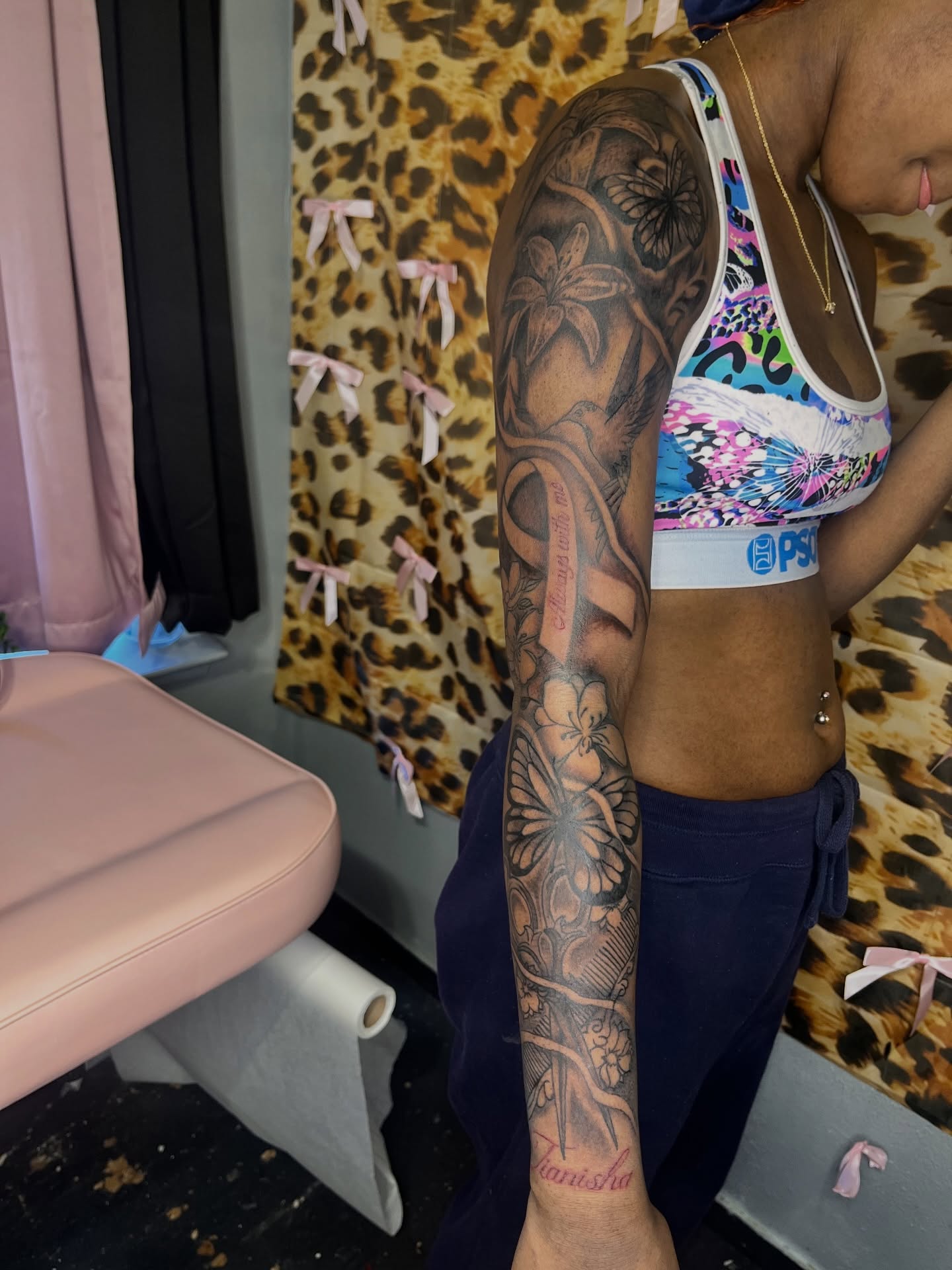 Floral and butterfly American traditional tattoo on the forearm by The inspo