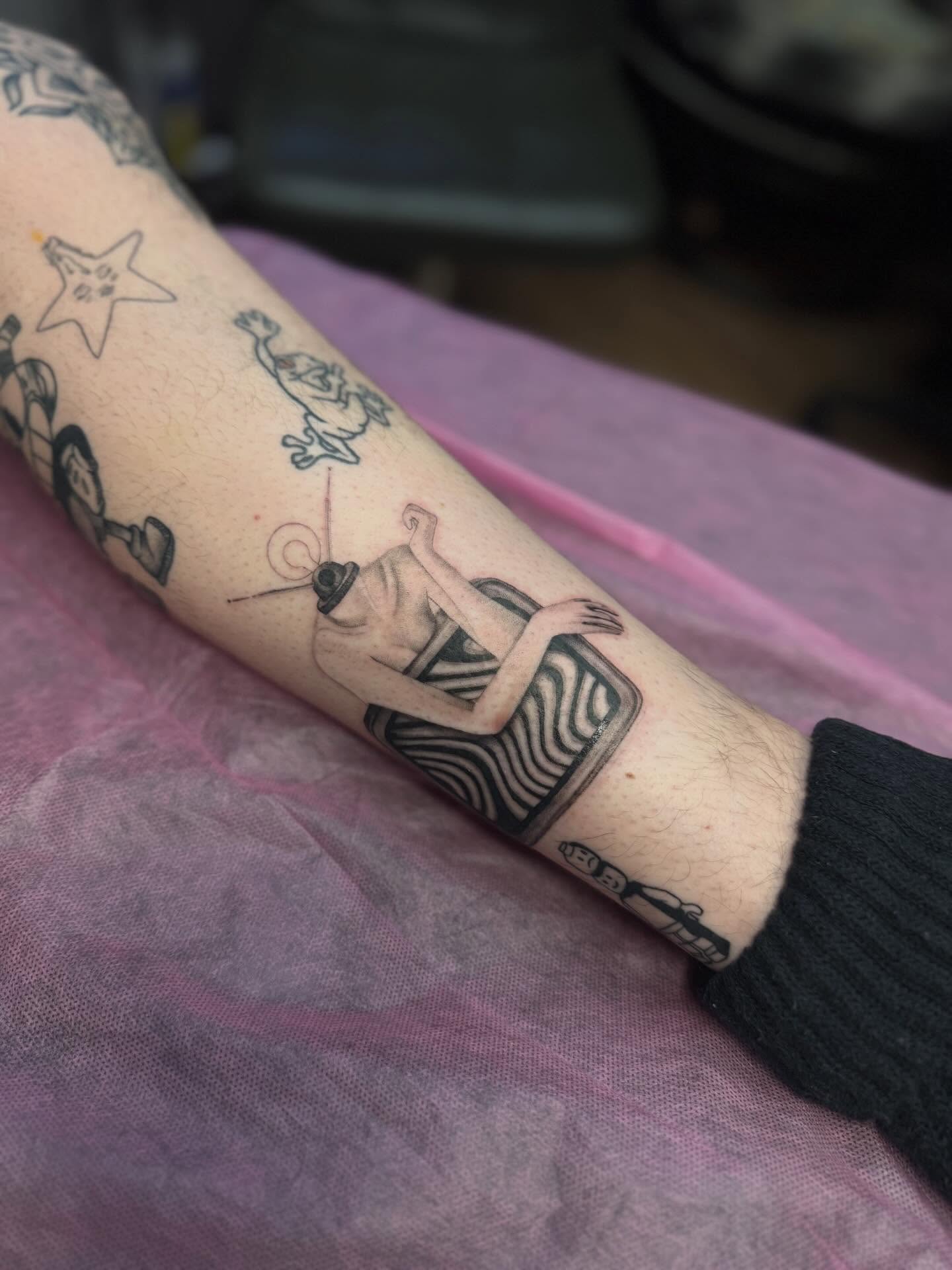 Woman in zebra print dress black and grey tattoo on the forearm by Anna