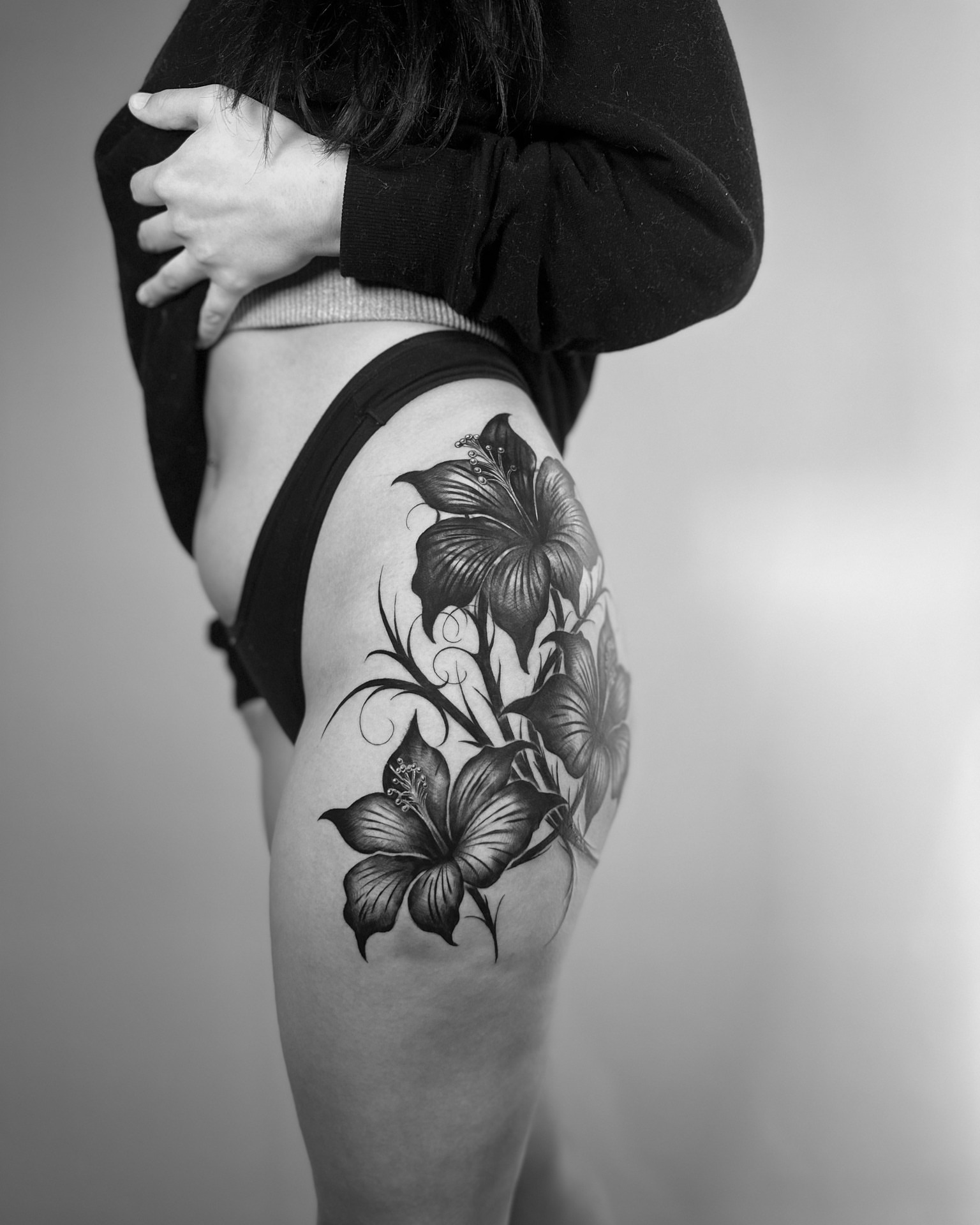 Hibiscus flowers black and grey tattoo on the thigh by Tattoos By Josh