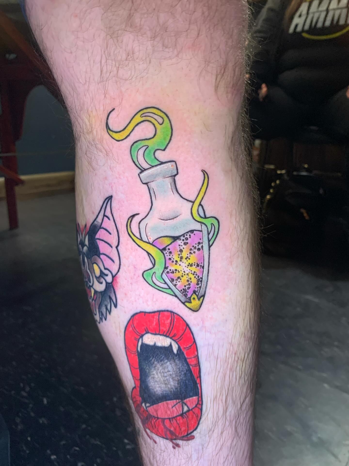 Vampire mouth and potion bottle American traditional tattoo on the forearm by Hannah Hahn