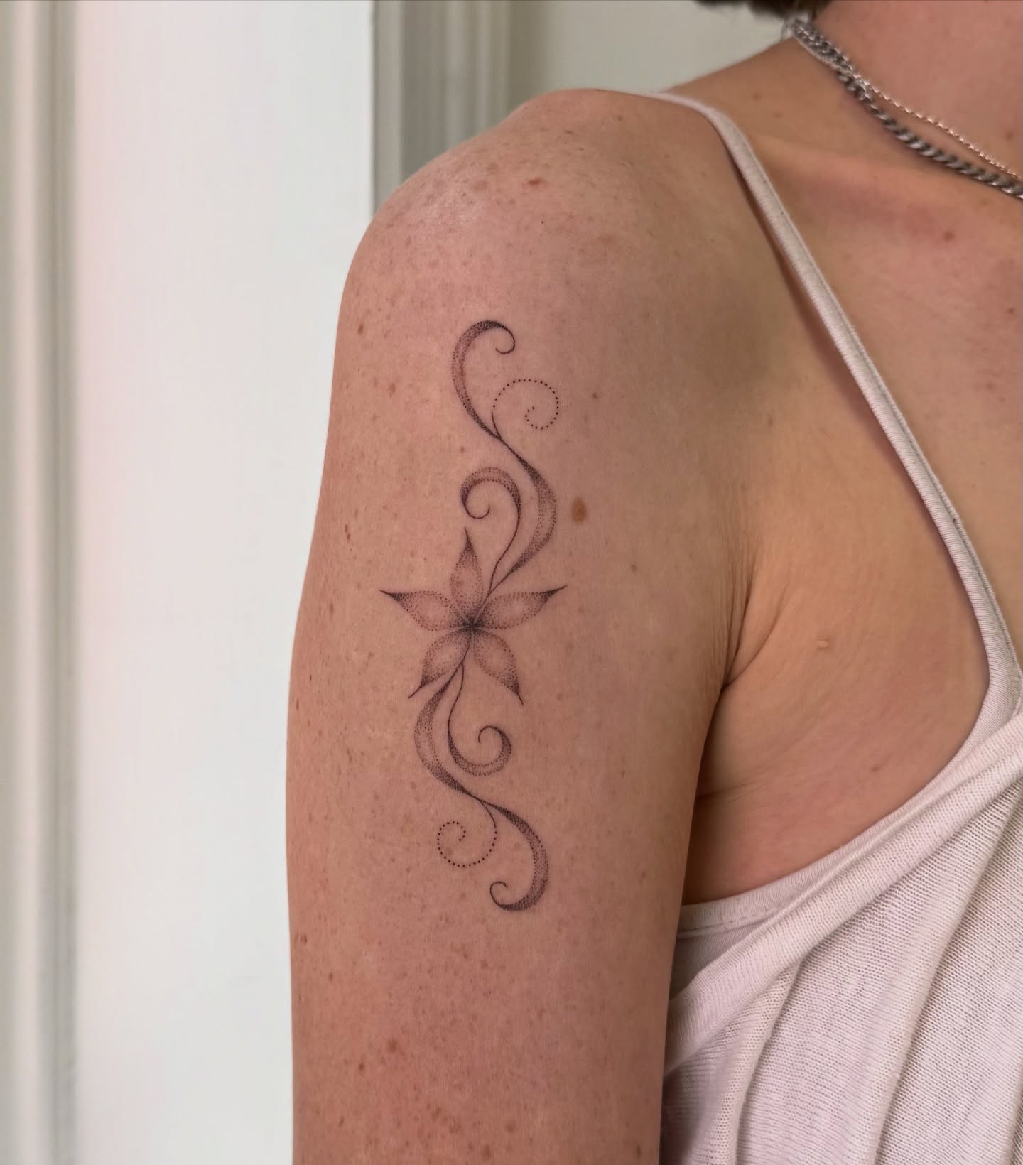 Floral design dotwork tattoo on the upper arm by Soomin
