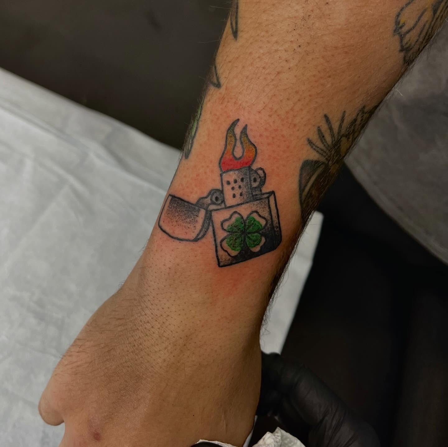Lighter with flame dotwork tattoo on the forearm by Mason McCubbin