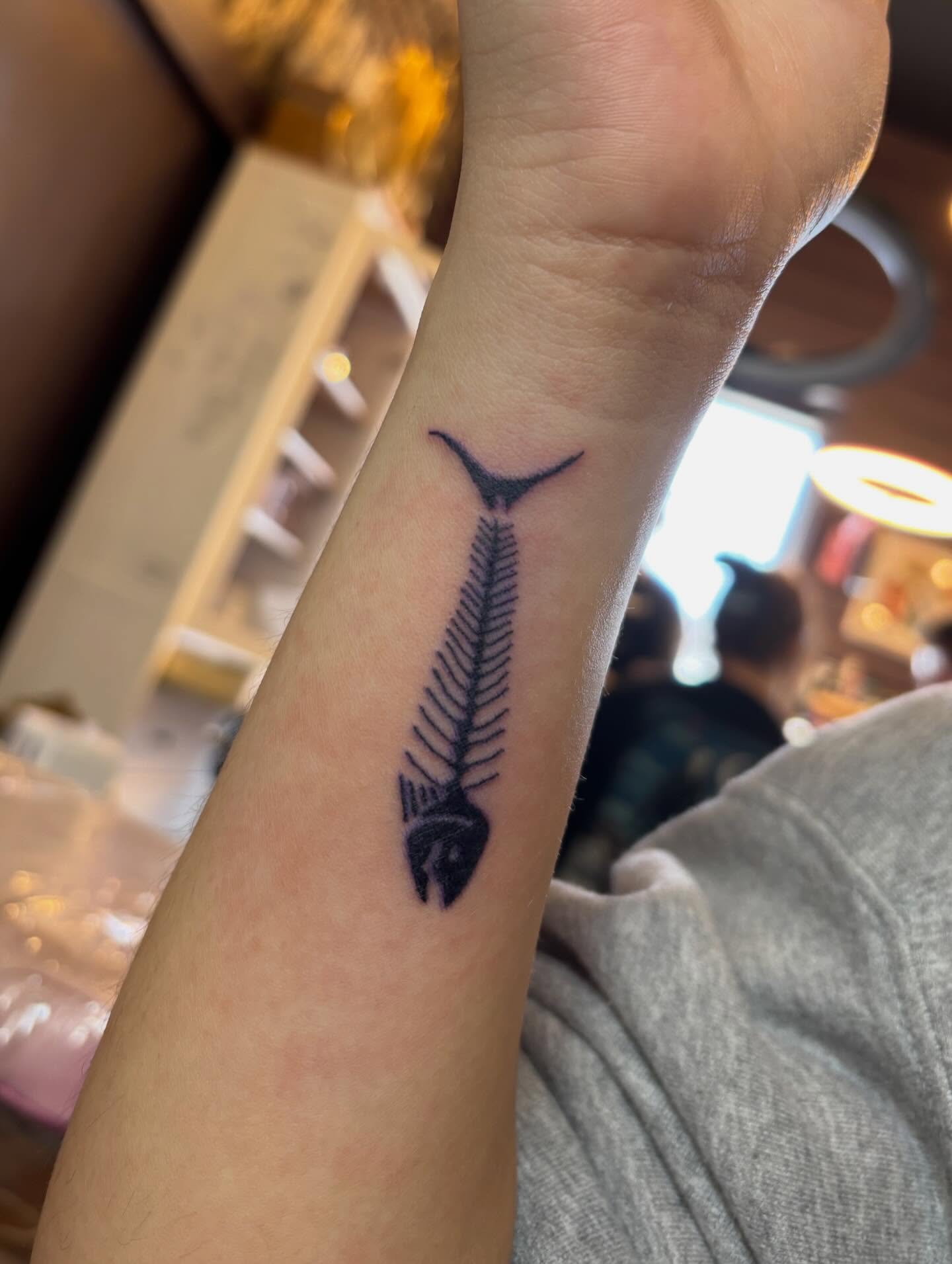 Fishbone black and grey tattoo on the forearm by Turner