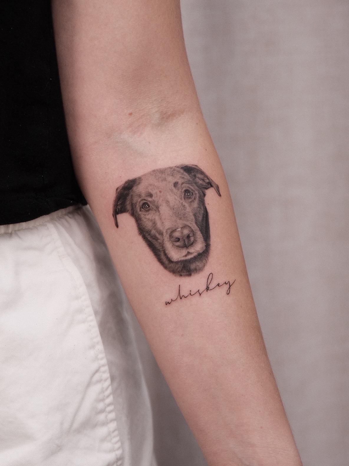Dog realism tattoo on the forearm by Houston Tattoo Artist GoldenK