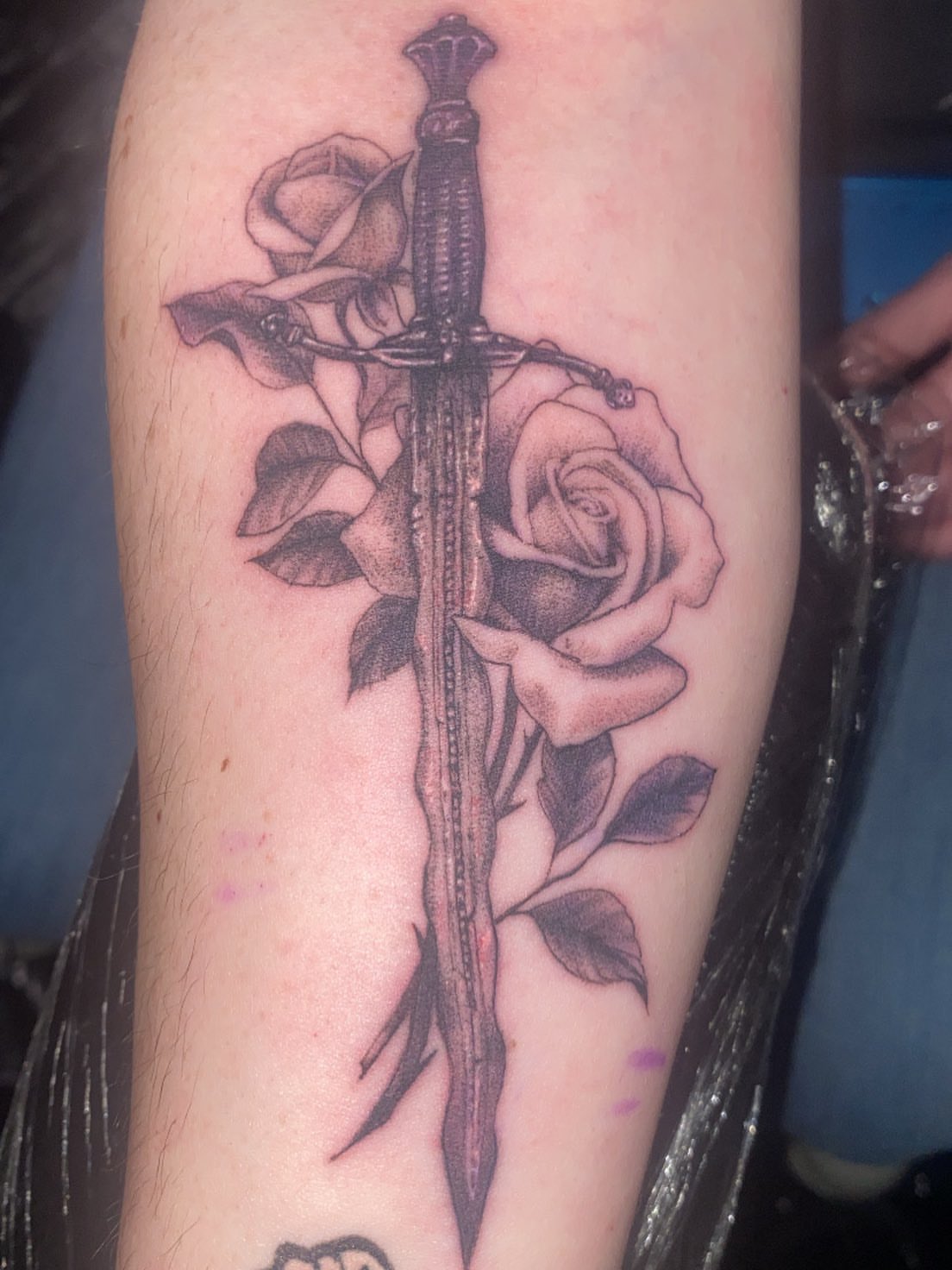 Sword and roses realism tattoo on the forearm by Hecho En El Bronx