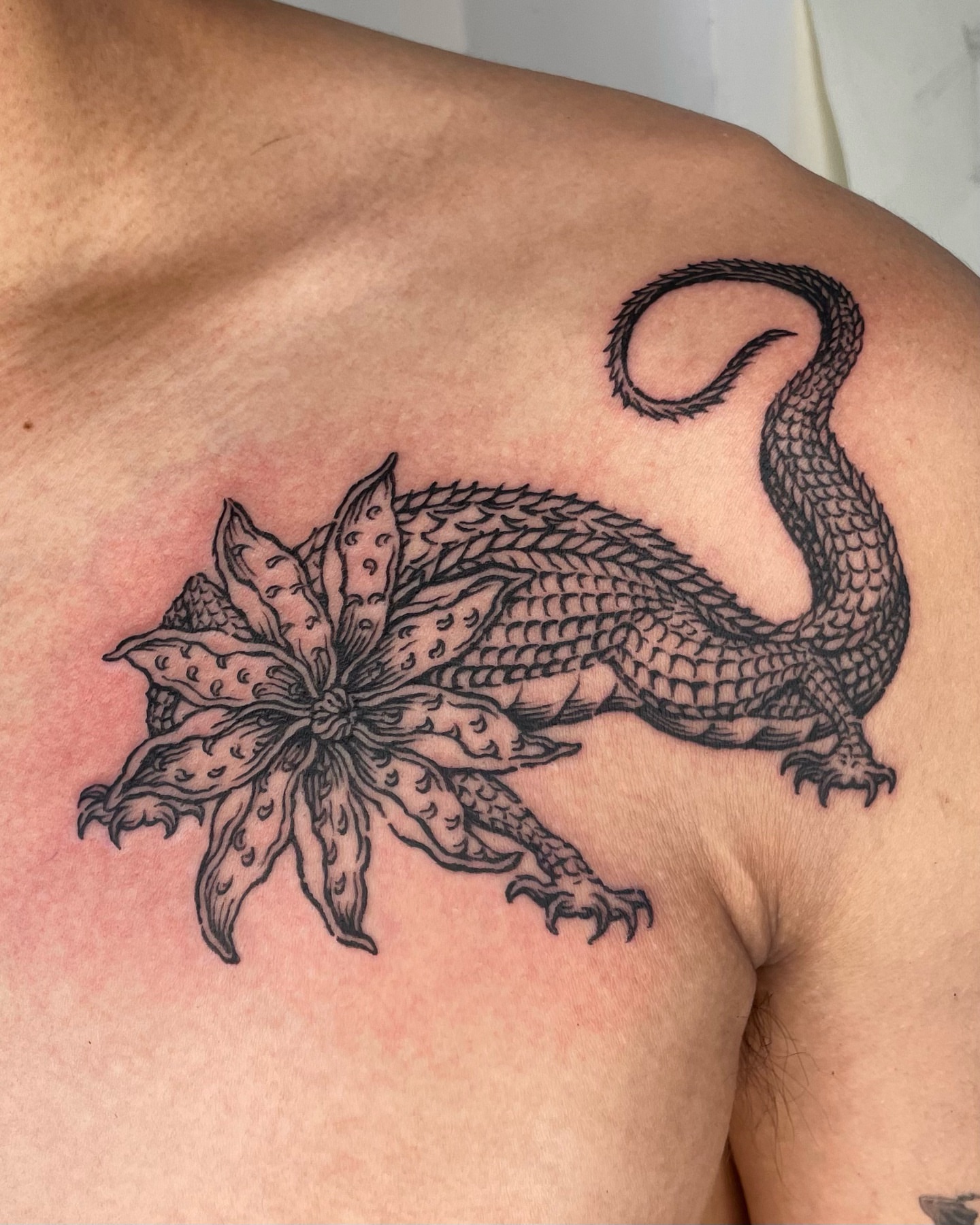 Dragon and flower black and grey tattoo on the shoulder by Anh Đan