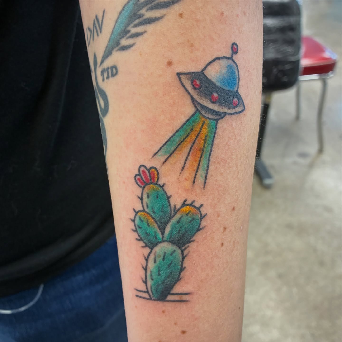 Spacecraft and cactus new school tattoo on the forearm by Kennedy Cole