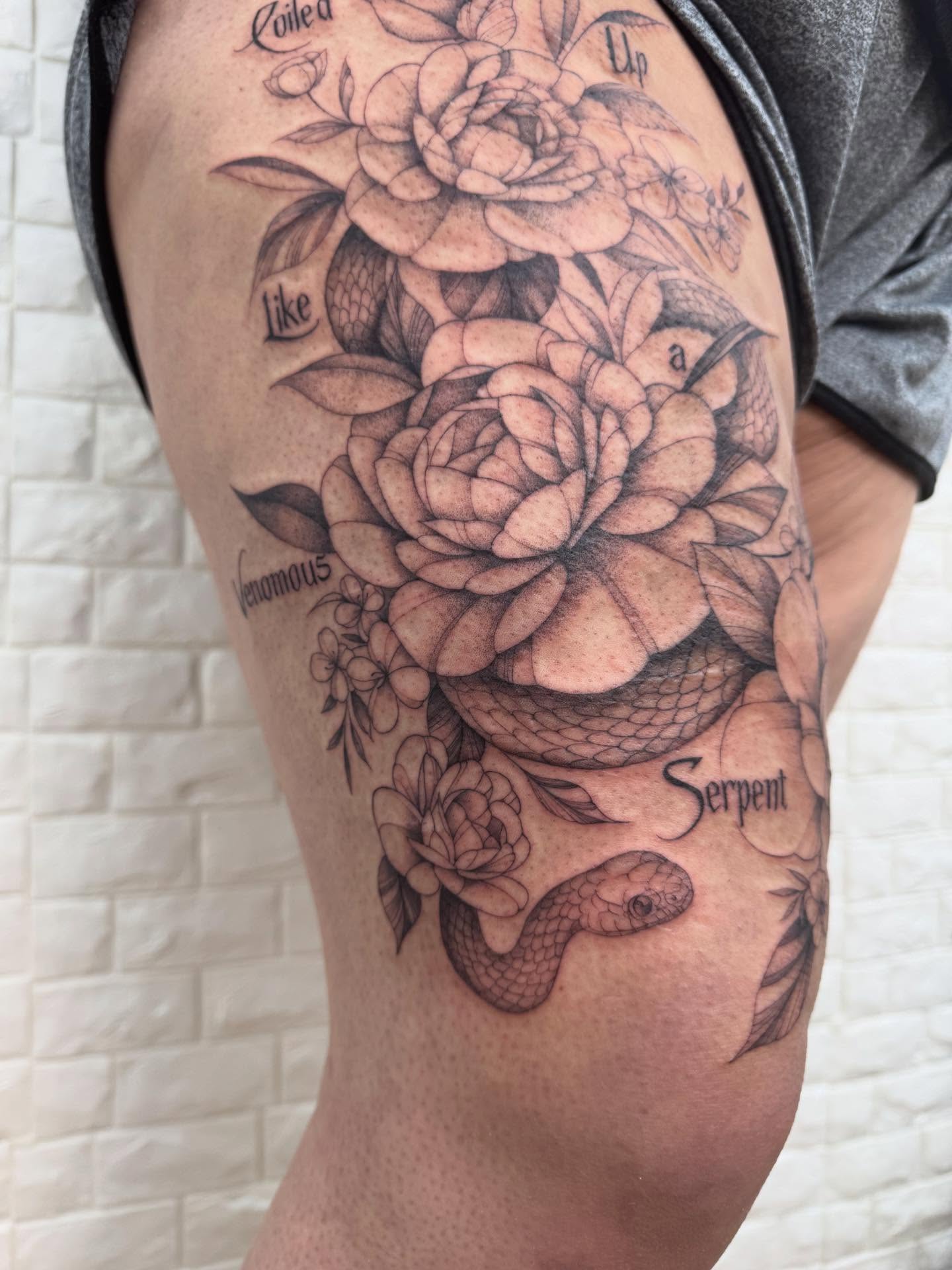 Snake and roses realism tattoo on the thigh by Danae Andino