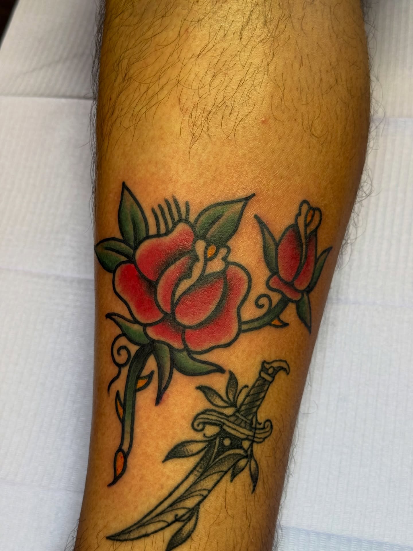 Roses and dagger American traditional tattoo on the forearm by @ryanpereztattoo