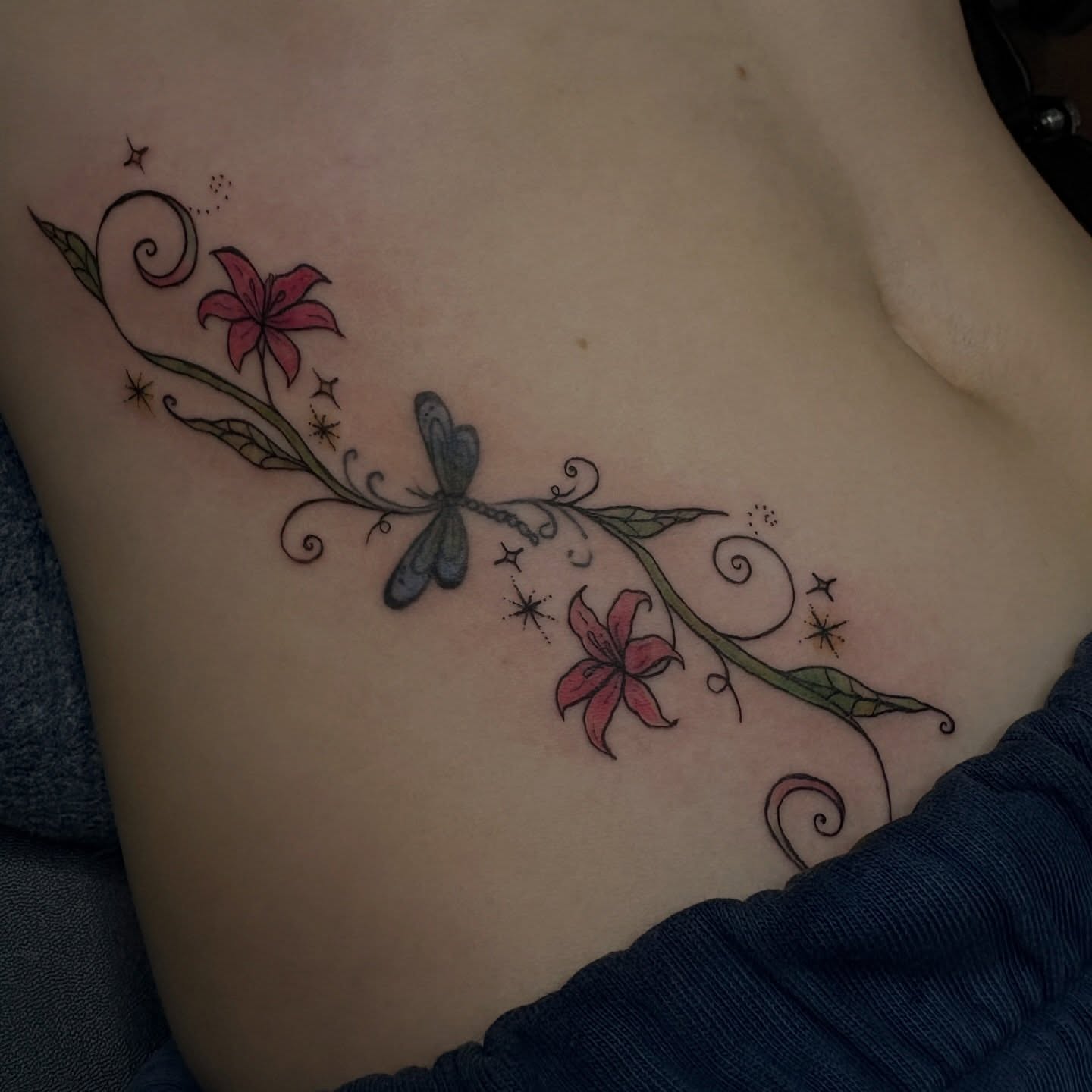Lily and dragonfly new school tattoo on the ribs by Emma🌸✨Austin Tattoo Artist