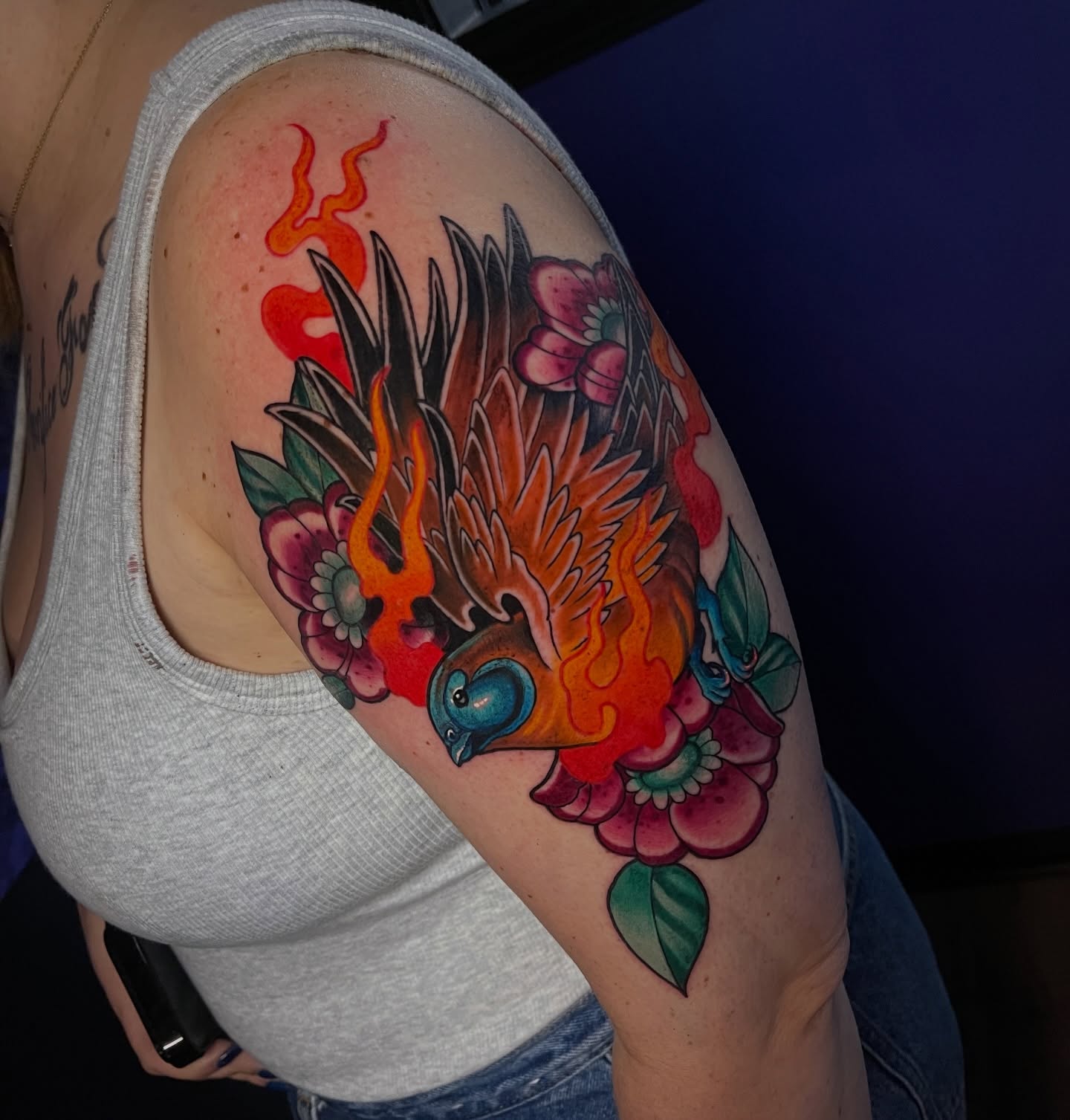 Bird and flowers American traditional tattoo on the shoulder by Corey Ryan