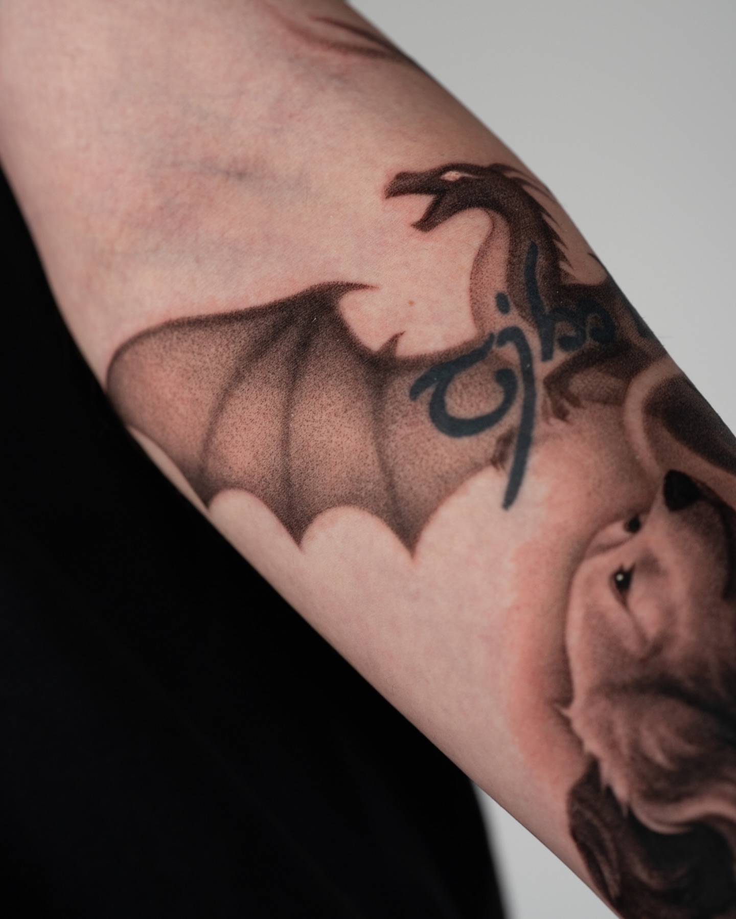 Dragon black and grey tattoo on the forearm by Toki