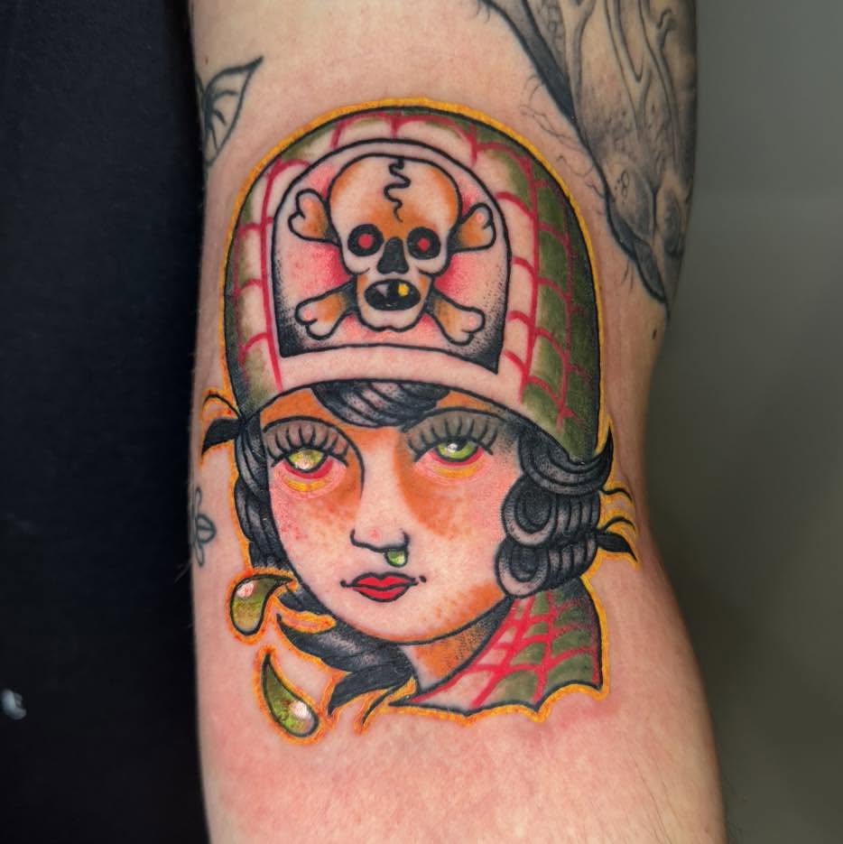 Woman wearing skull cap American traditional tattoo on the forearm by Tattoos by Aeron Herald Maurbjorn, Sioux