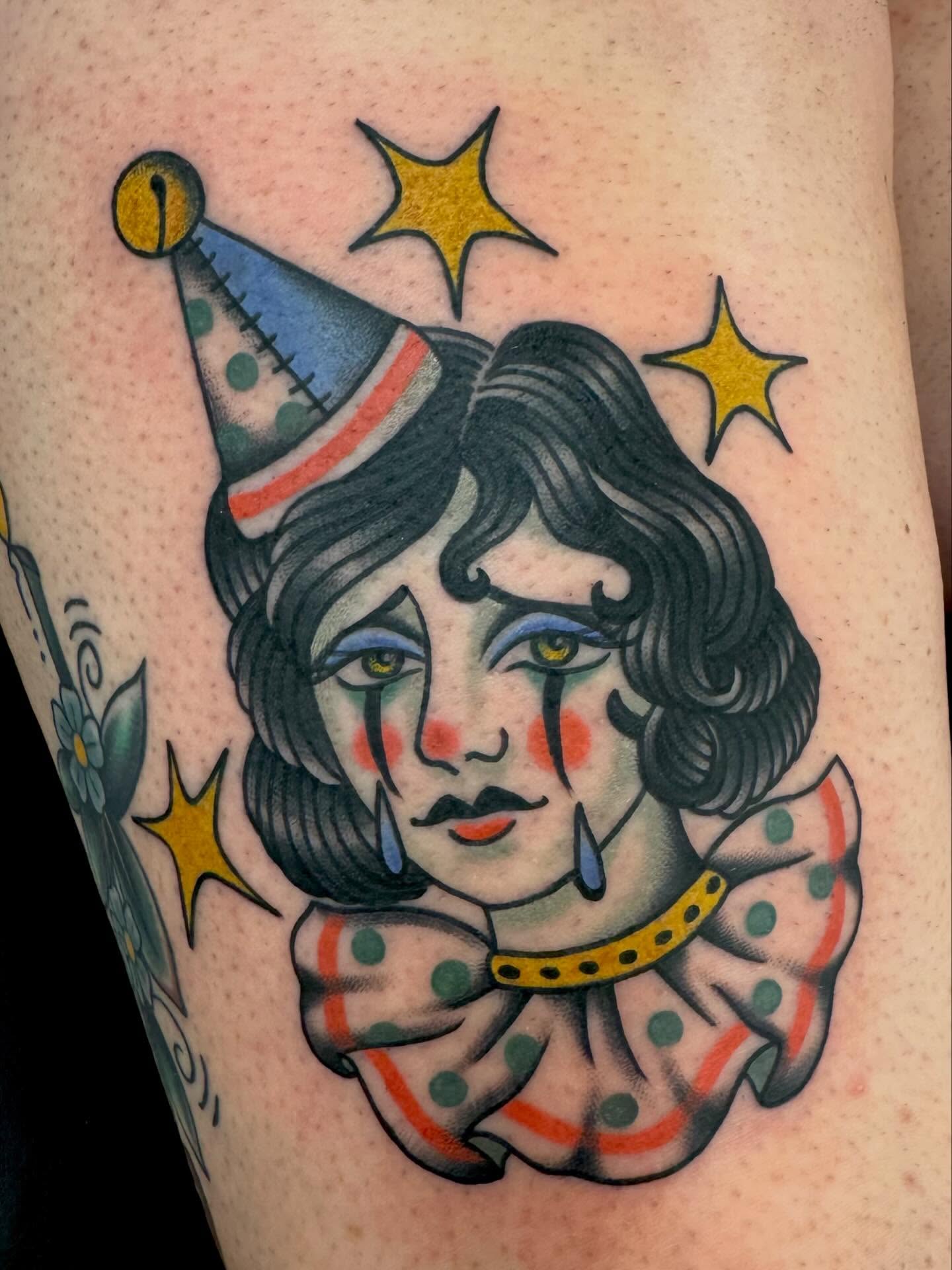 Clown American traditional tattoo on the thigh by Stefany