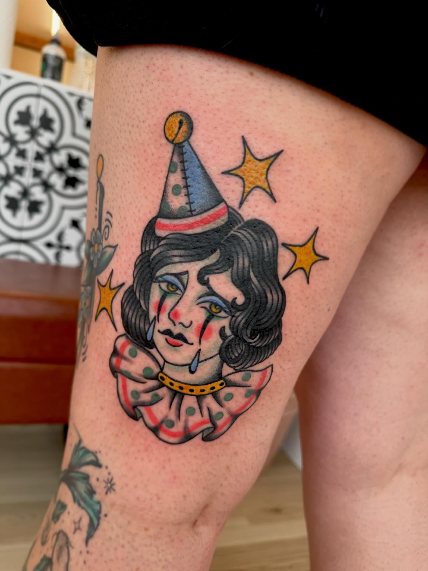 Clown American traditional tattoo on the thigh by Stefany