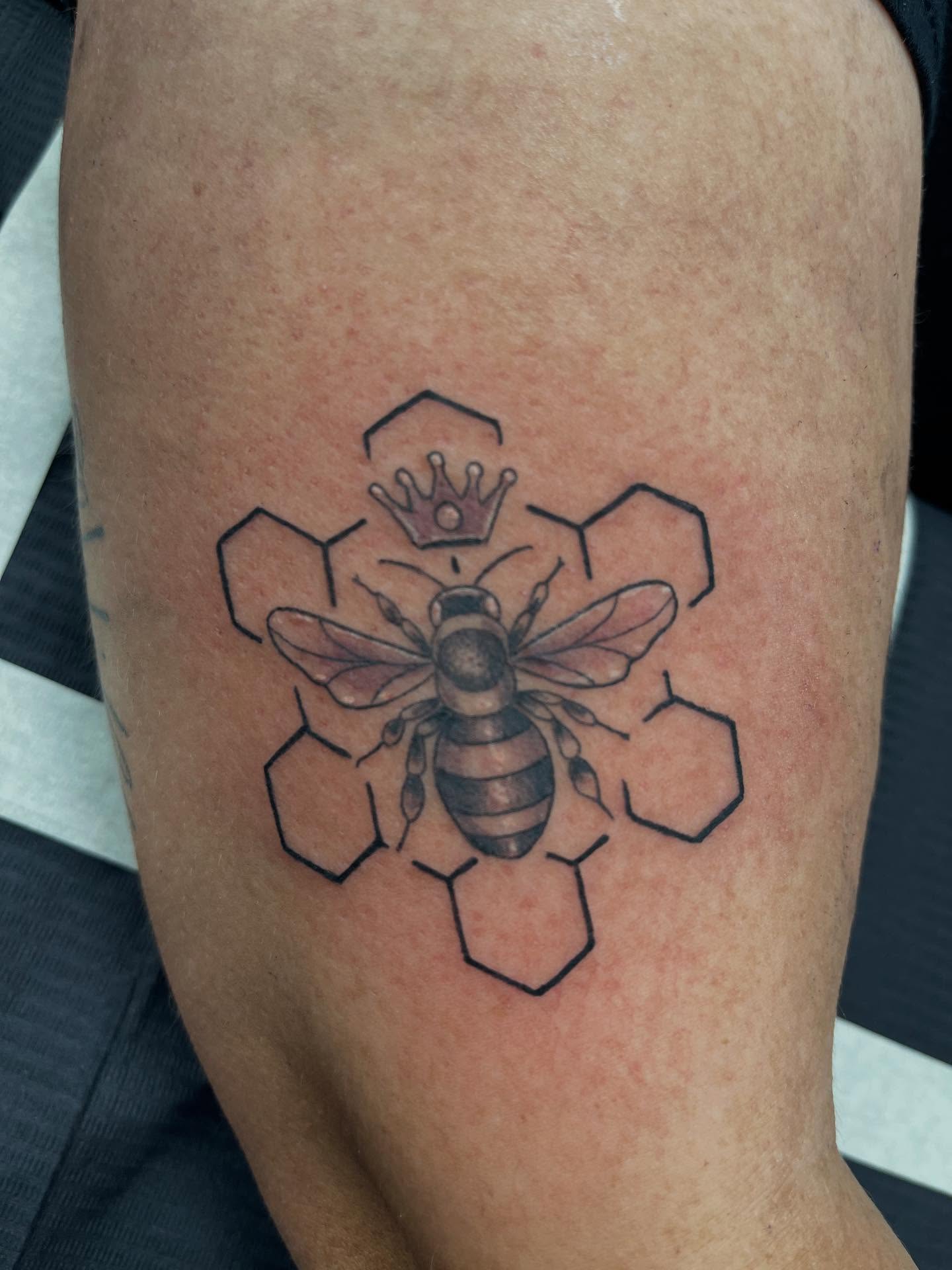 Bee and honeycomb black and grey tattoo on the thigh by @artinjections667