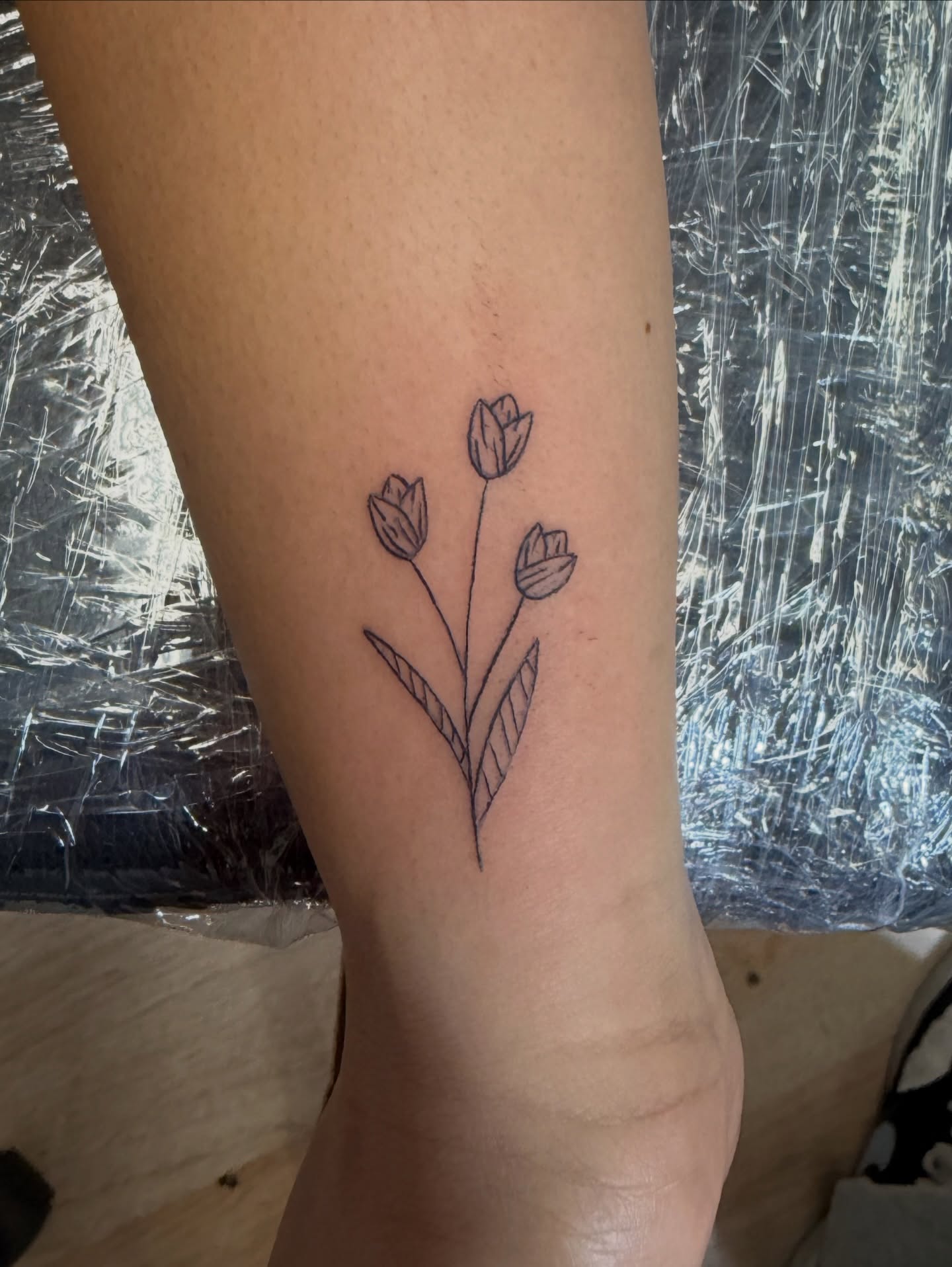 Tulips minimalist tattoo on the forearm by Inky Birdz Tattoos