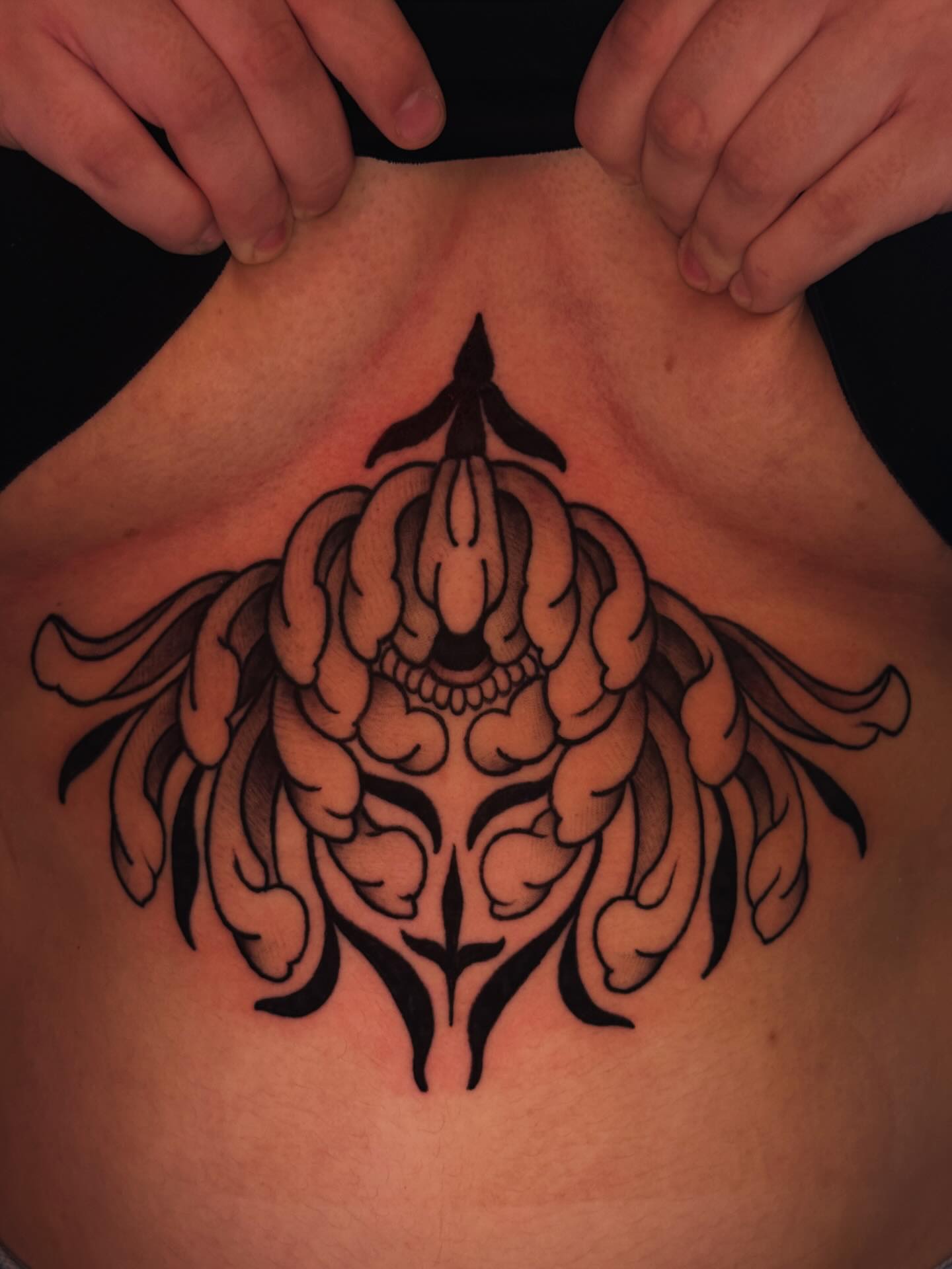 Mask tribal tattoo on the back by Jessica Haug