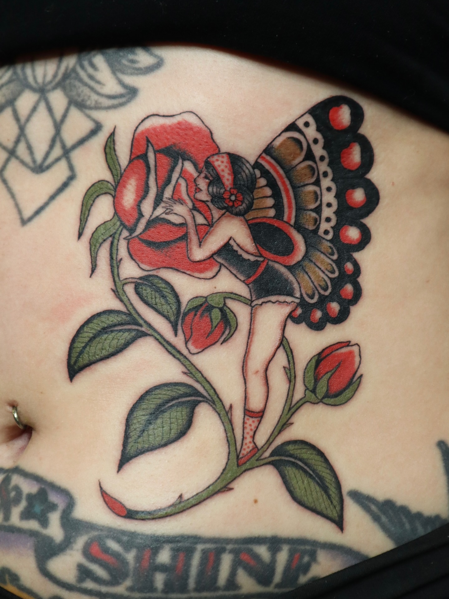 Fairy and rose American traditional tattoo on the torso by Kate Ortiz