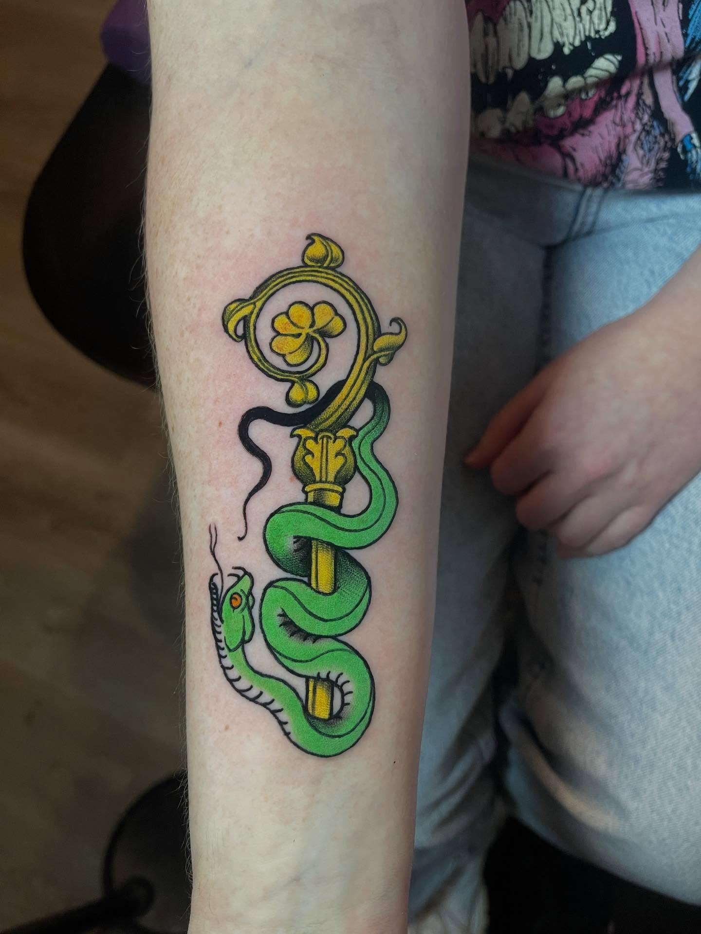 Snake and staff new school tattoo on the forearm by Joe Moreira