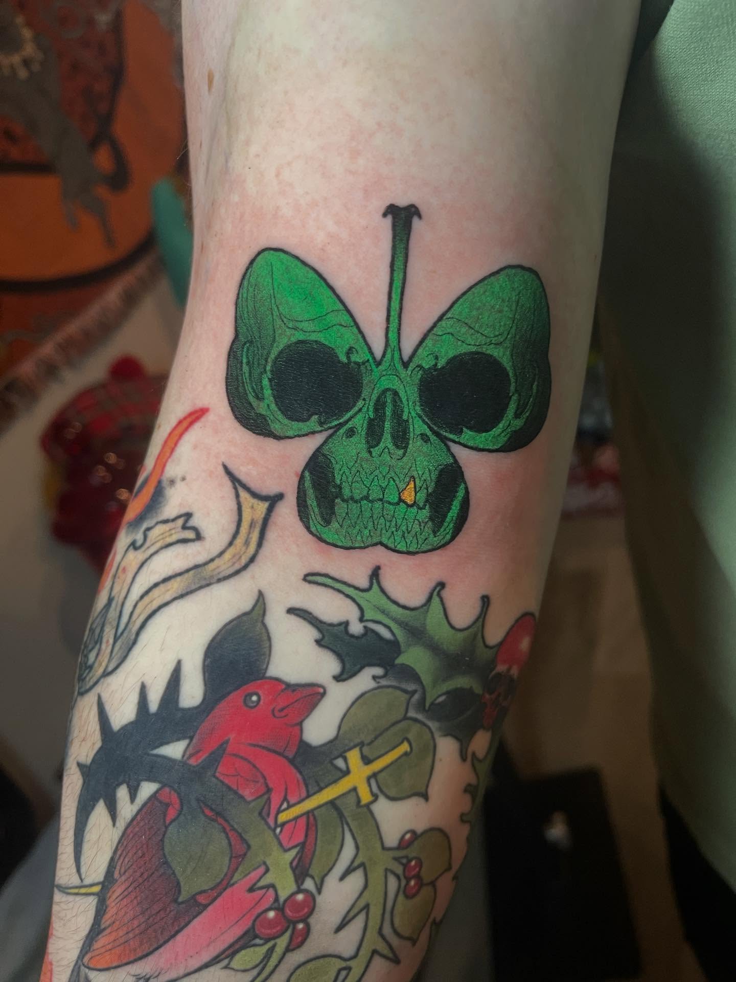 Skull with butterfly wings American traditional tattoo on the forearm by Joe Moreira