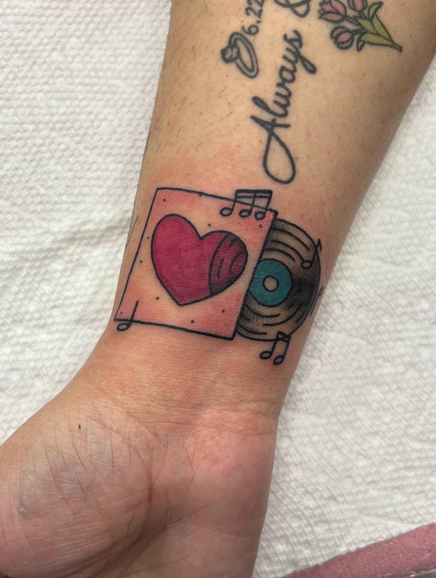 Heart and record American traditional tattoo on the forearm by Courtney