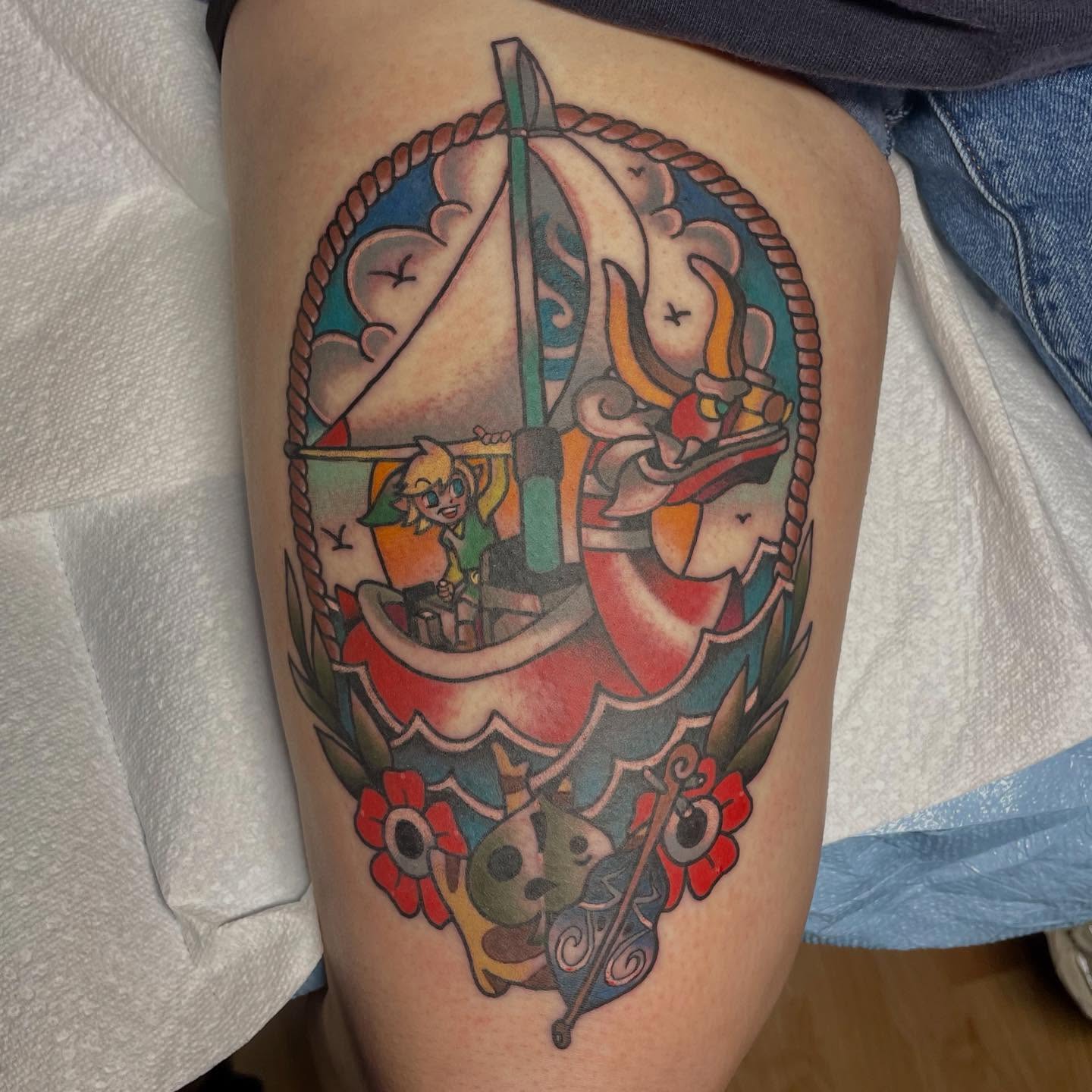 Zelda and boat American traditional tattoo on the thigh by Robert Morrow