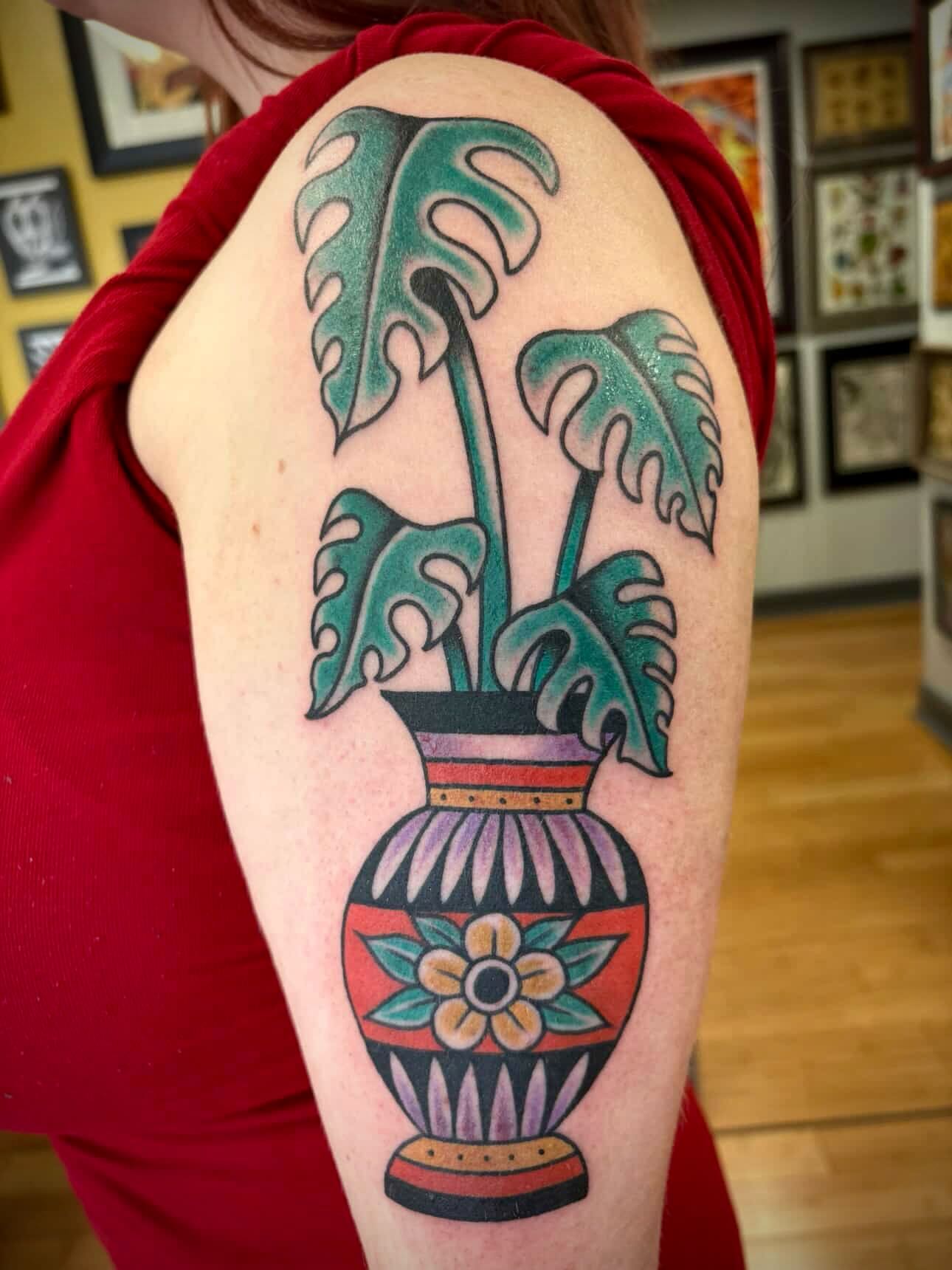 Monstera plant in vase American traditional tattoo on the upper arm by Micheal McGlinchey