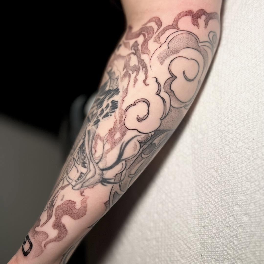 Clouds and dragon japanese irezumi tattoo on the forearm by Haylie Adele Strong