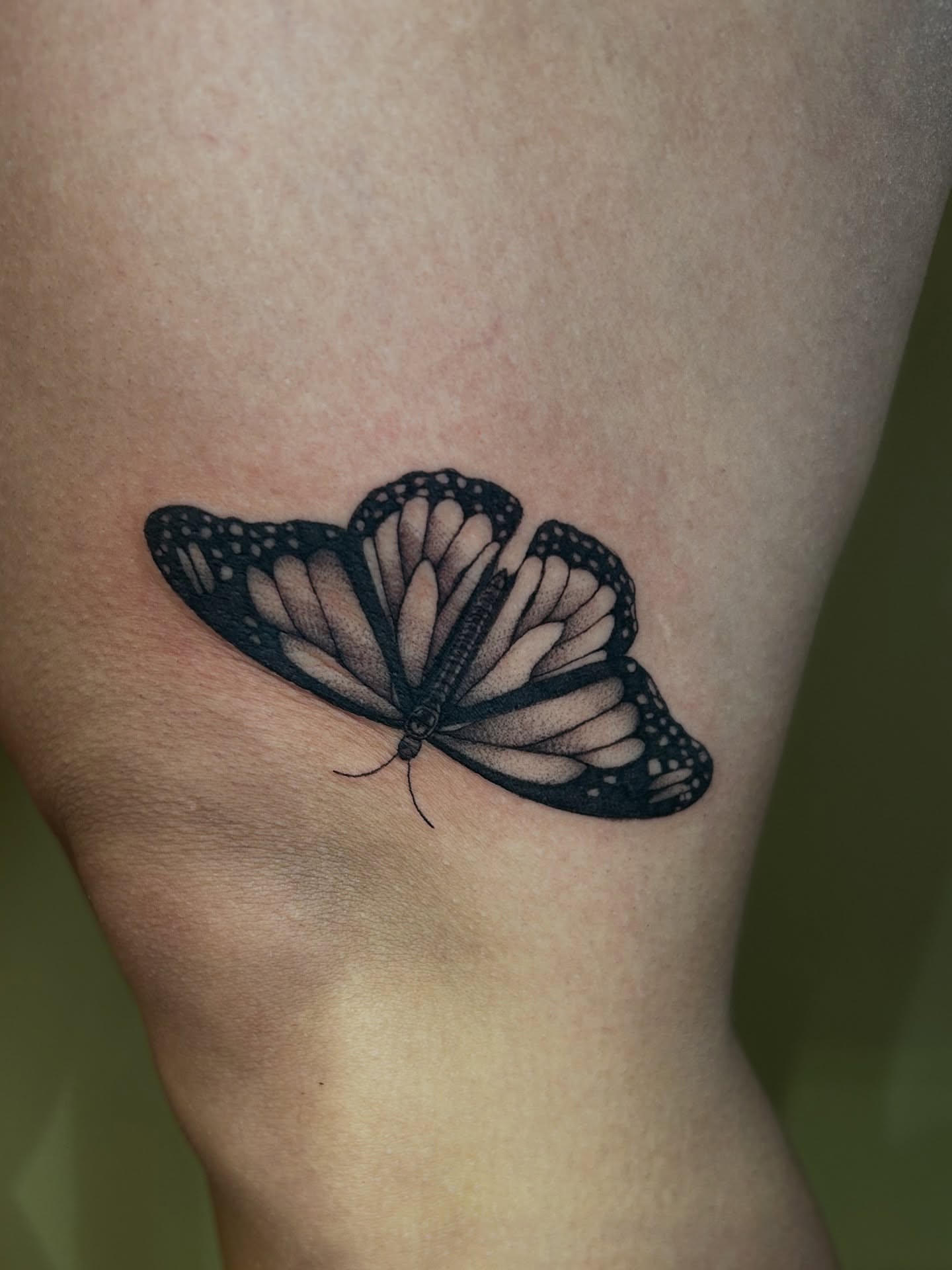 Monarch butterfly realism tattoo on the thigh by Cassy D, Miami, Florida