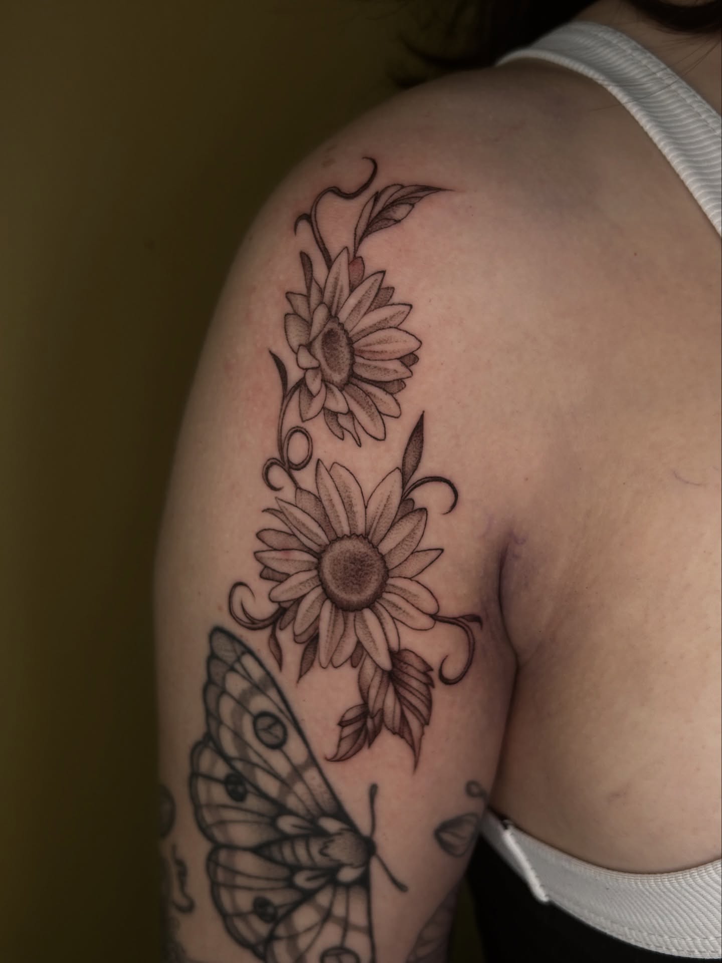 Sunflowers and butterfly black and grey tattoo on the shoulder by Cassy D, Miami, Florida