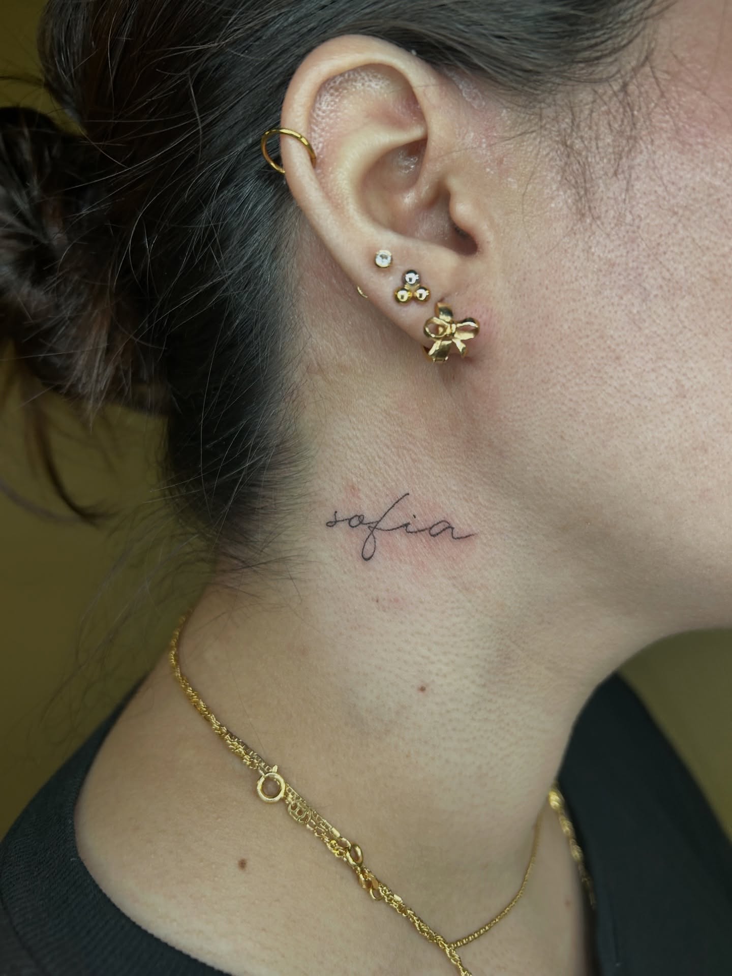 Name lettering script tattoo on the neck by Cassy D, Miami, Florida